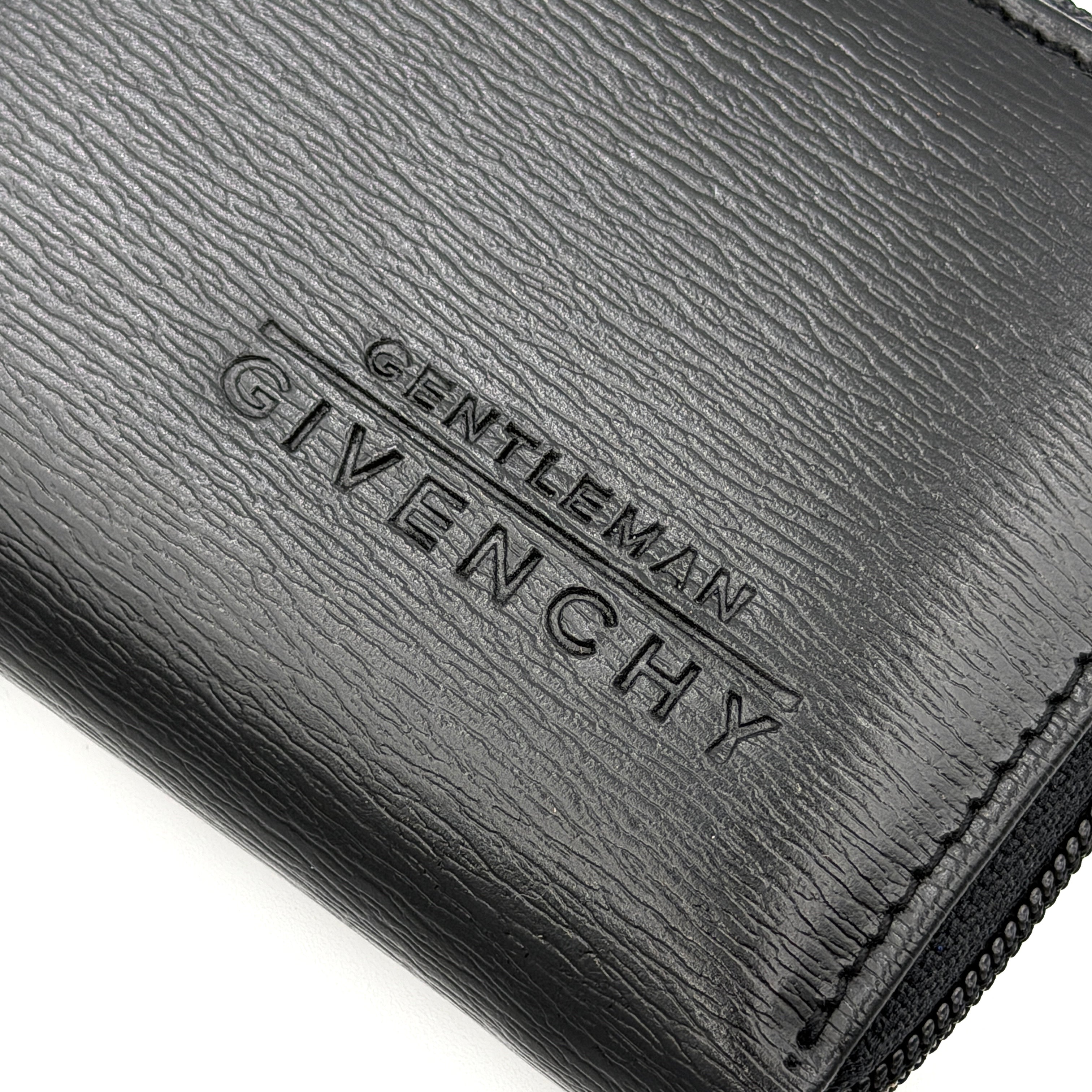 Givenchy Gentleman black leather coin purse with zip-around closure, shown against a white background.