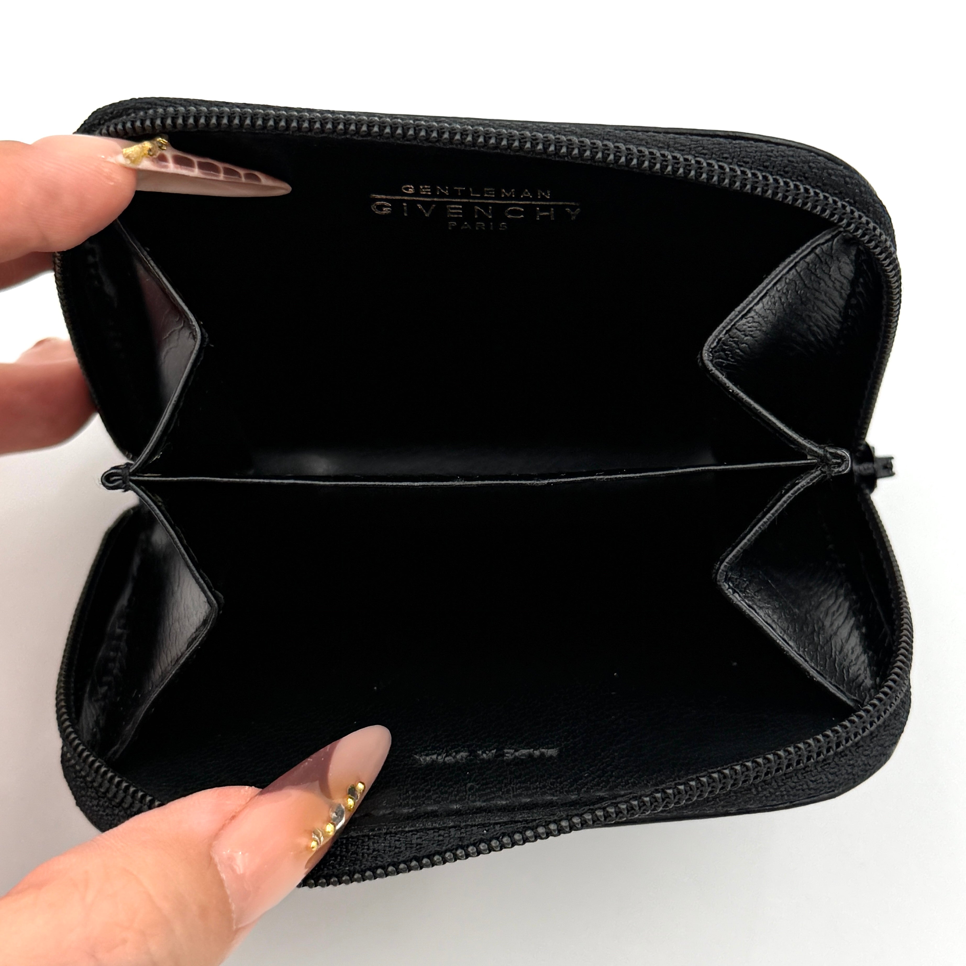 Givenchy Gentleman black leather coin purse with zip-around closure, shown against a white background.