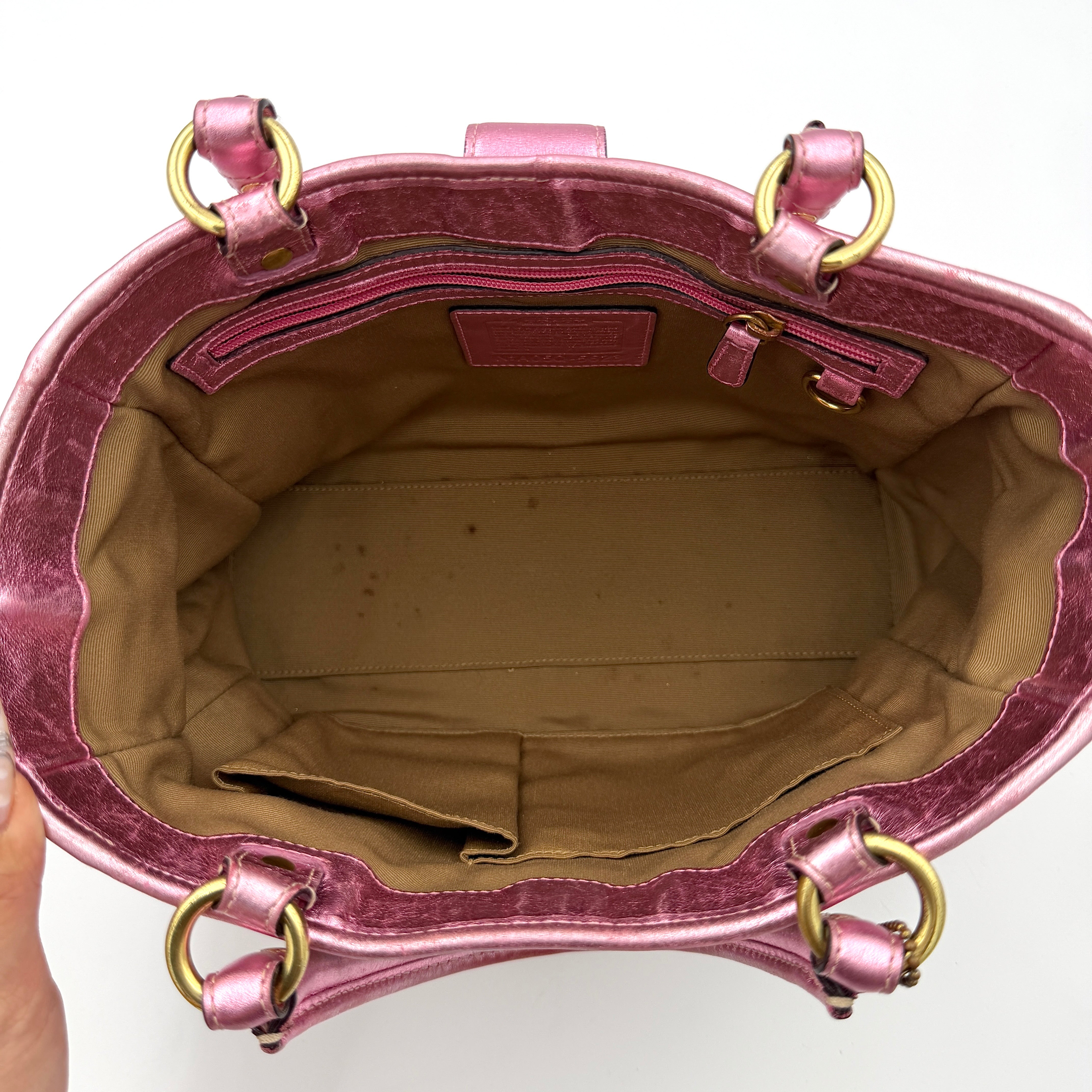 Coach Soho Buckle Tote featuring baby pink metallic leather trim and beige signature jacquard canvas with gold-tone hardware.