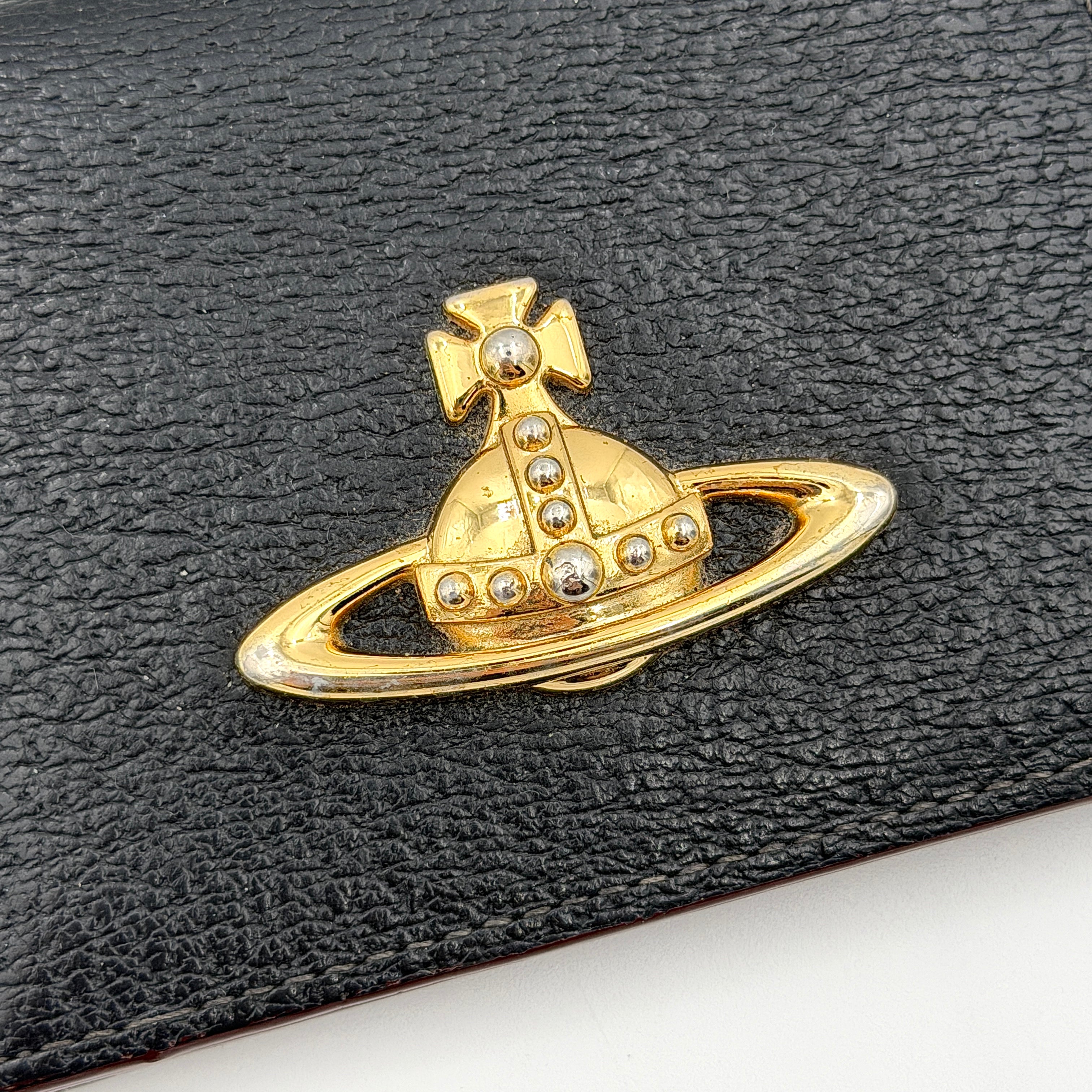 Vivienne Westwood black grained leather cardholder with gold orb emblem on the front flap.