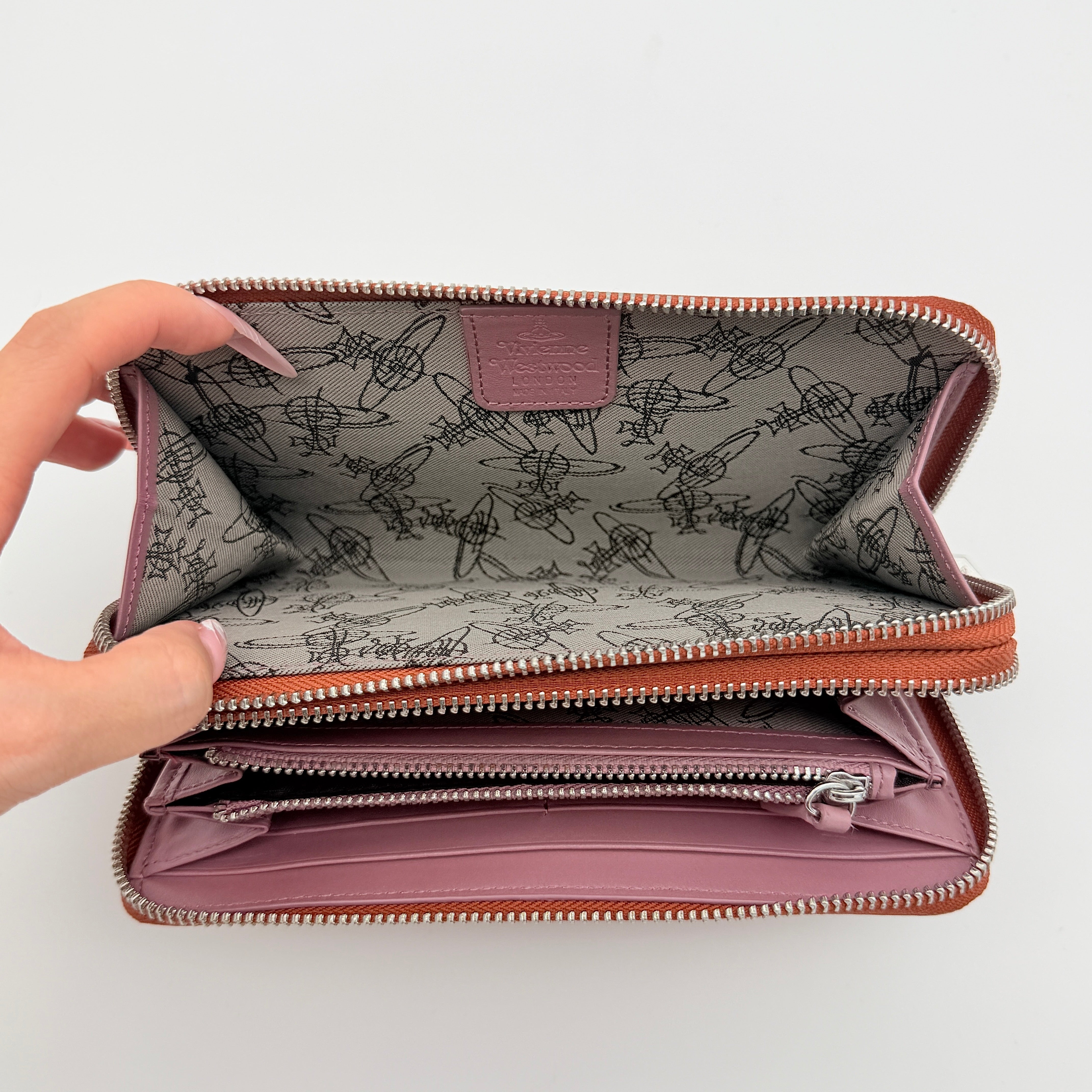 Vivienne Westwood 2Way Signature Orb Embossed Shoulder Wallet in coral pink leather with removable shoulder strap, shown with silver hardware.