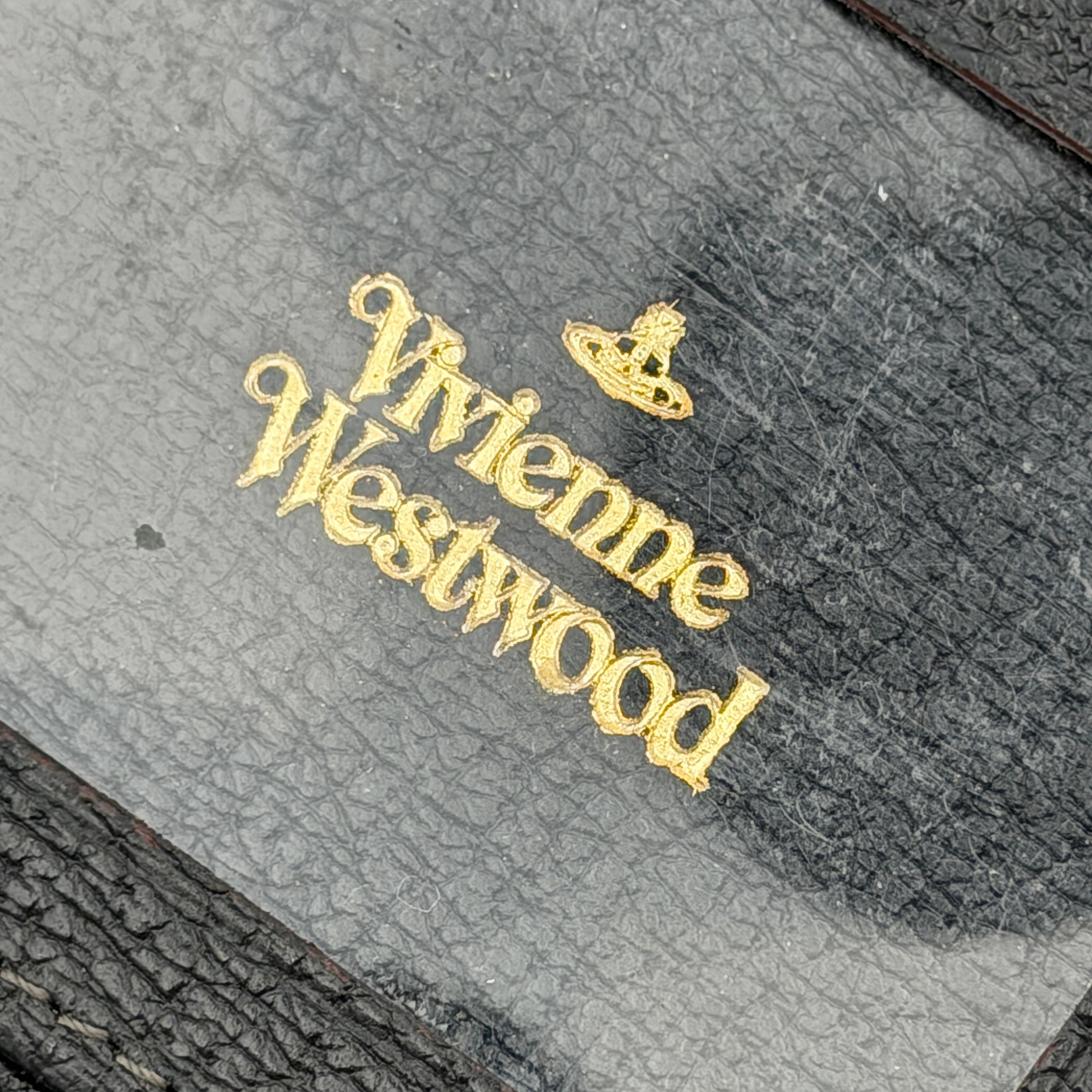 Vivienne Westwood black grained leather cardholder with gold orb emblem on the front flap.
