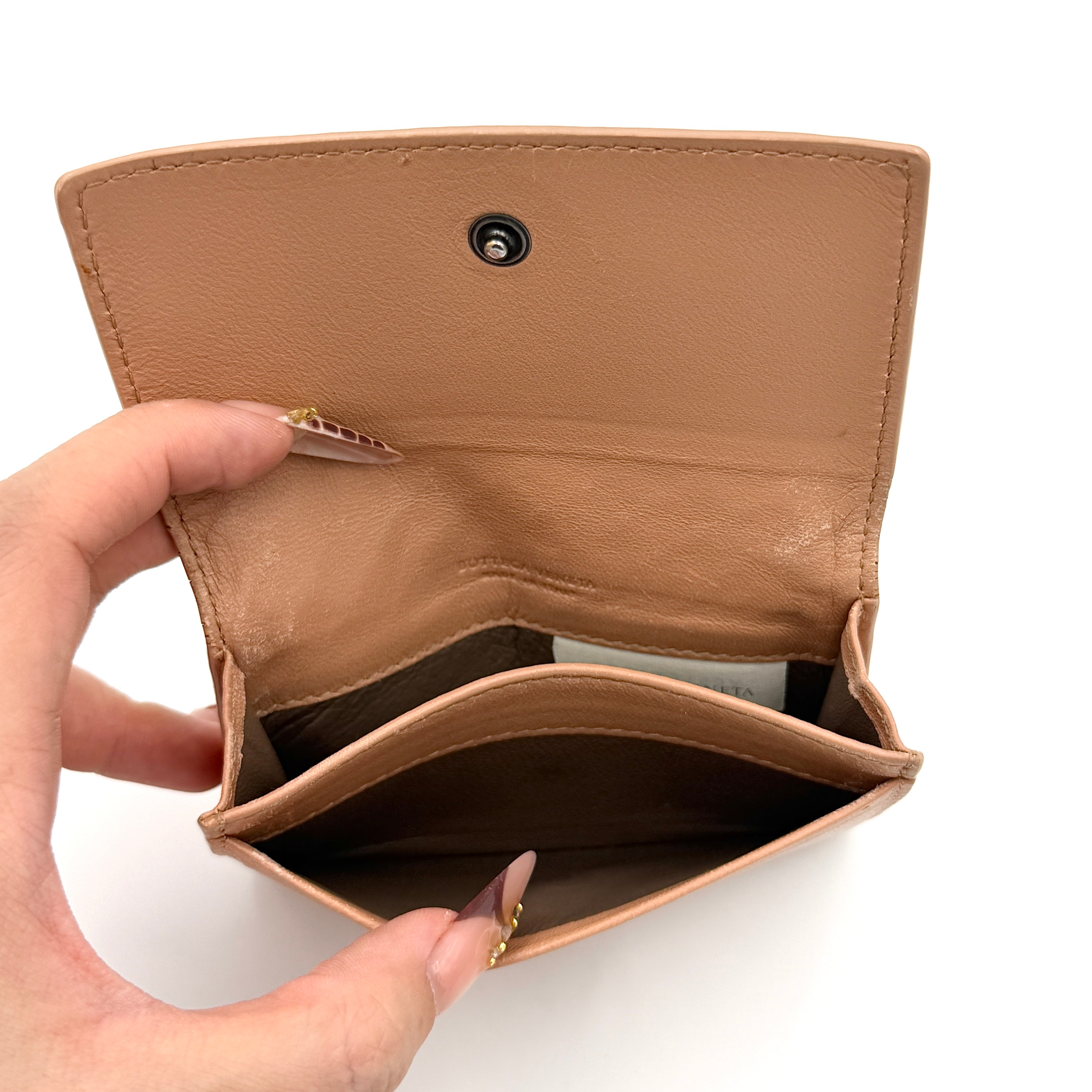 Bottega Veneta beige intrecciato leather card holder with woven front panel, shown on a plain background.