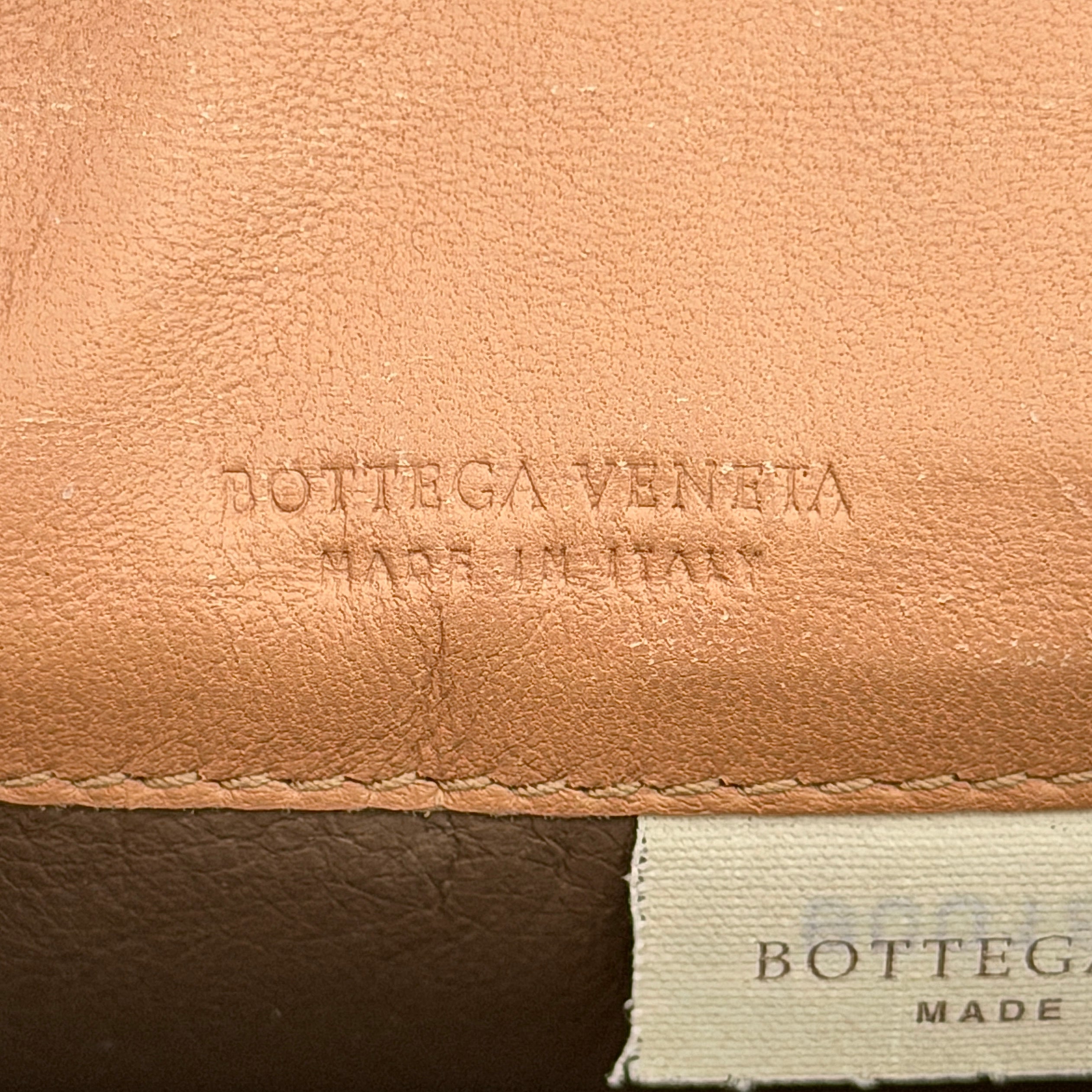 Bottega Veneta beige intrecciato leather card holder with woven front panel, shown on a plain background.