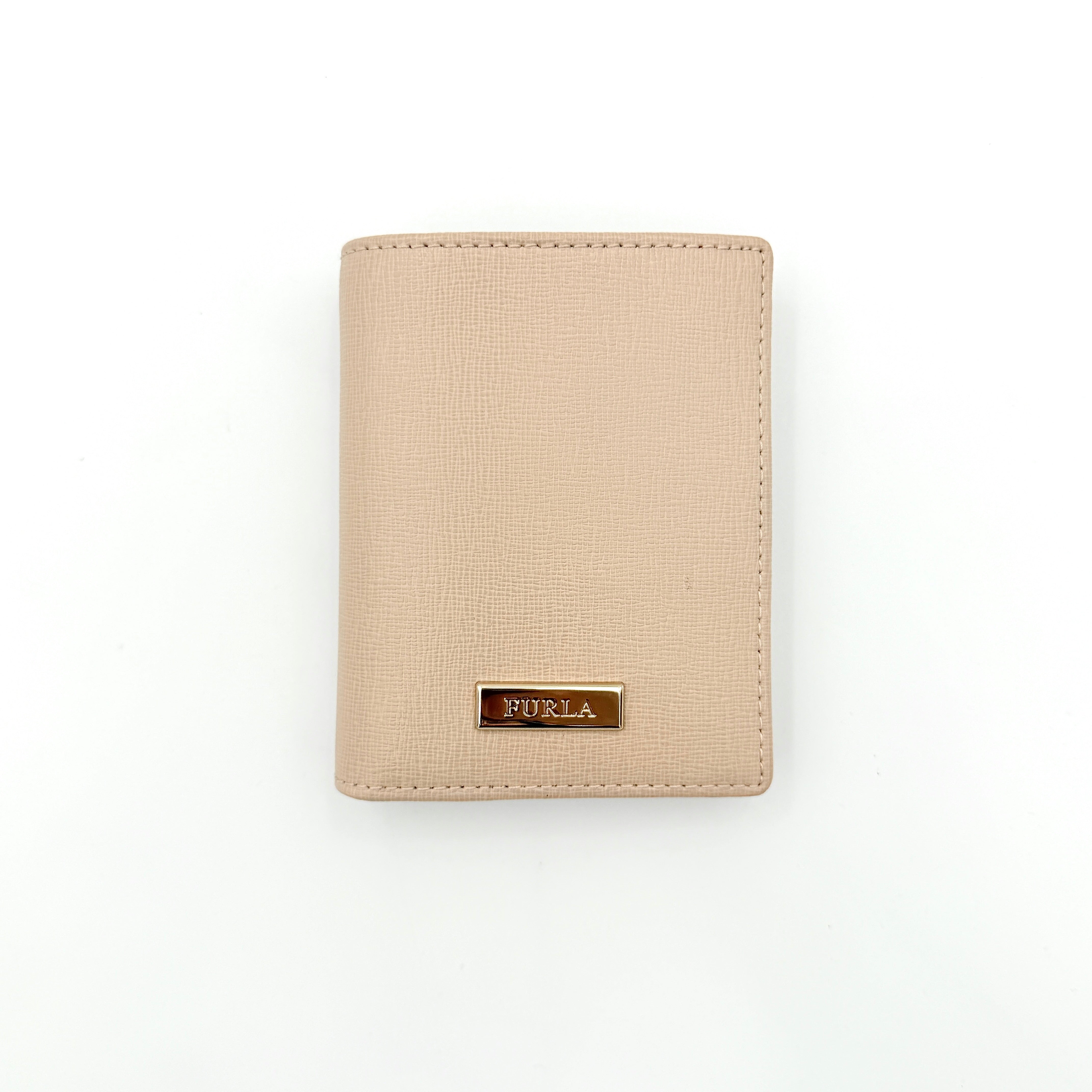 Furla Camelia S Compact Wallet in beige leather with gold-tone logo plaque, photographed against a clean white background.