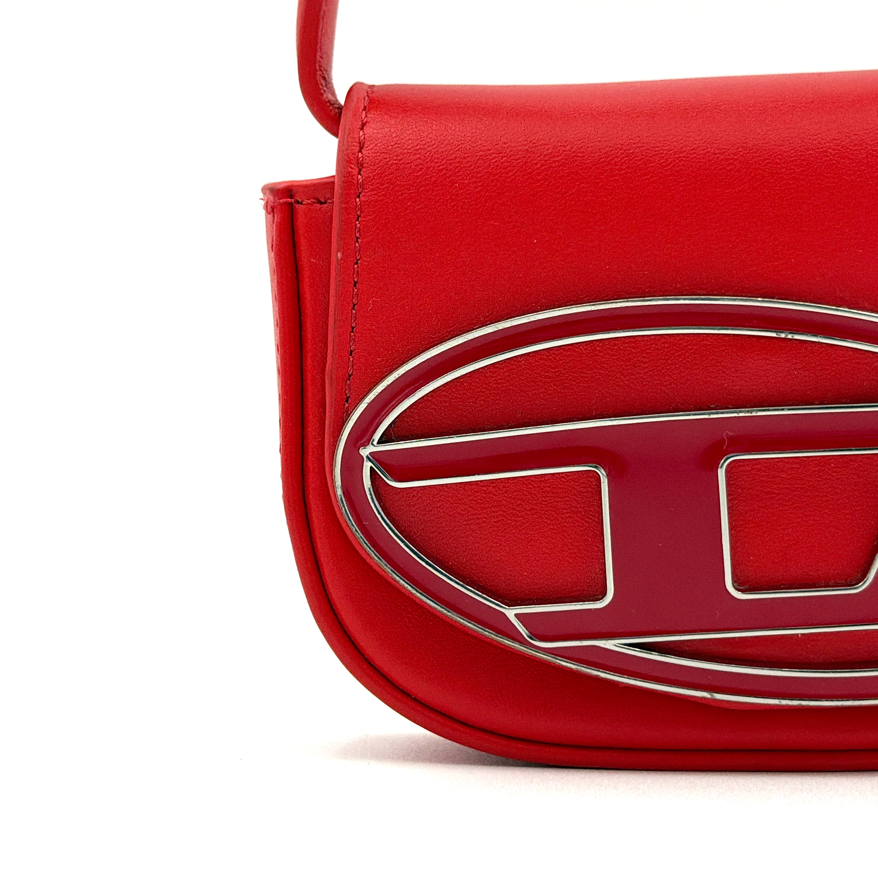 Diesel 2Way 1DR-XS Mini Bag in striking red leather with bold silver D logo, paired with a detachable matching strap.