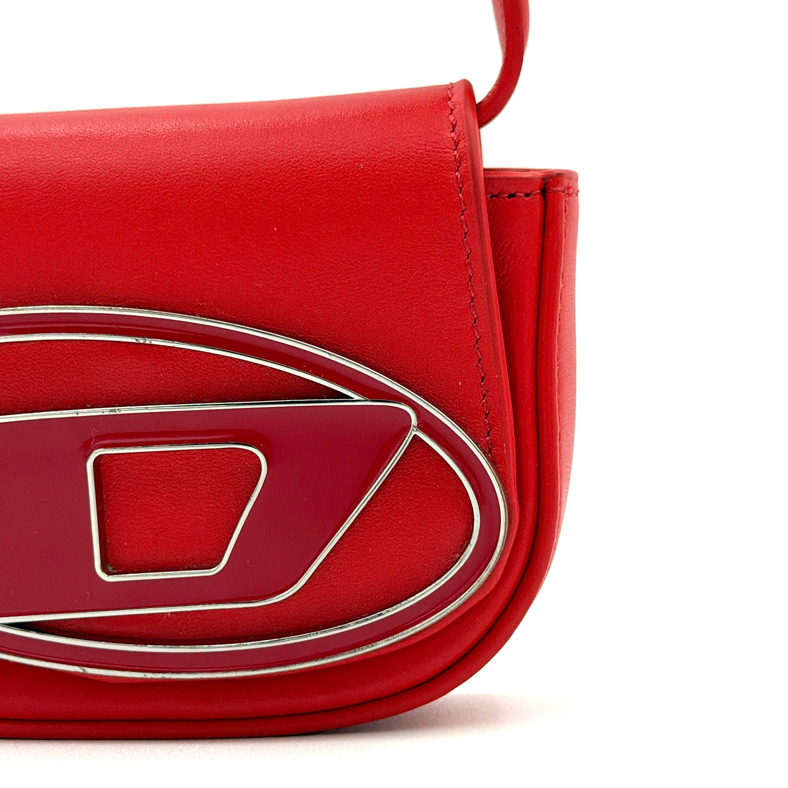 Diesel 2Way 1DR-XS Mini Bag in striking red leather with bold silver D logo, paired with a detachable matching strap.
