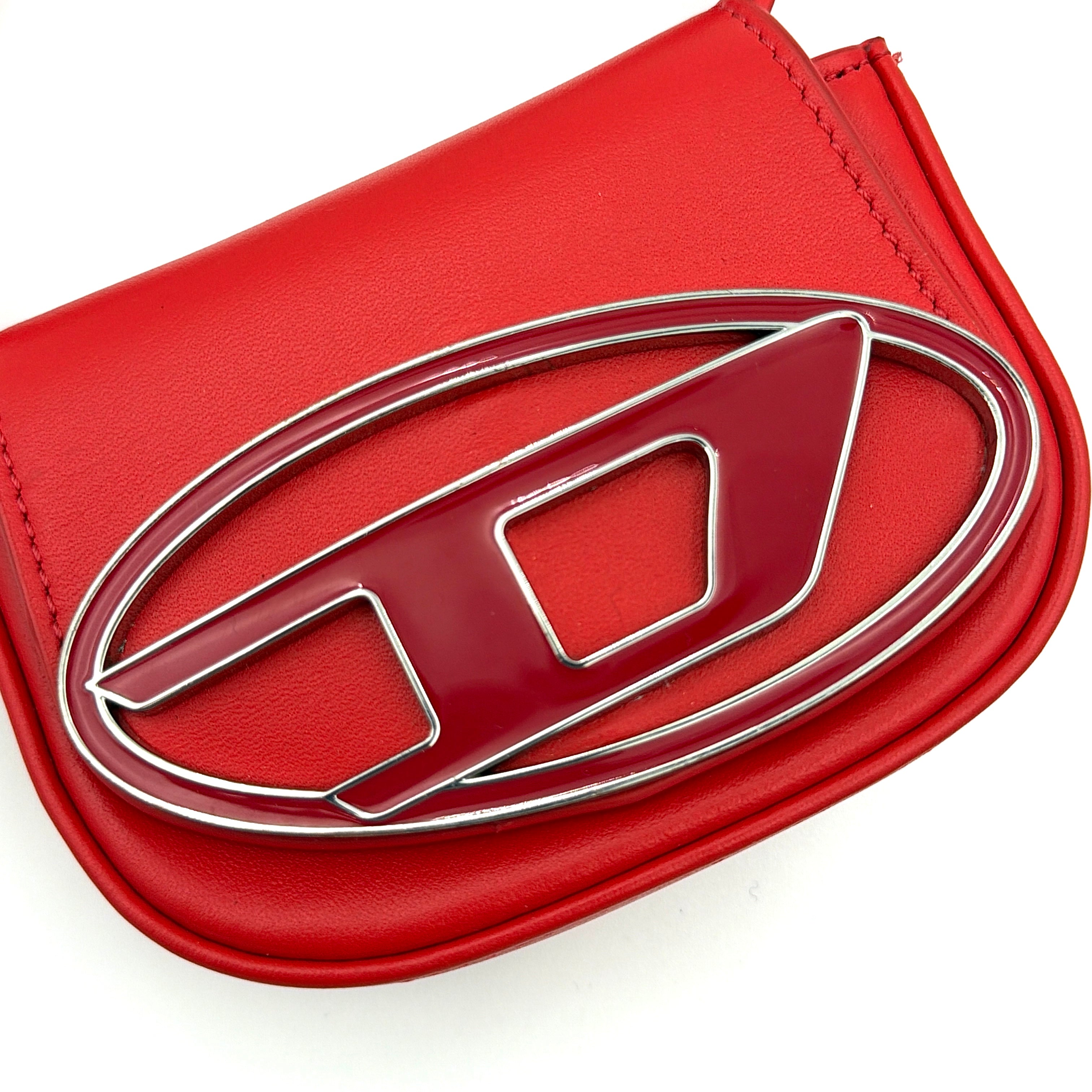 Diesel 2Way 1DR-XS Mini Bag in striking red leather with bold silver D logo, paired with a detachable matching strap.