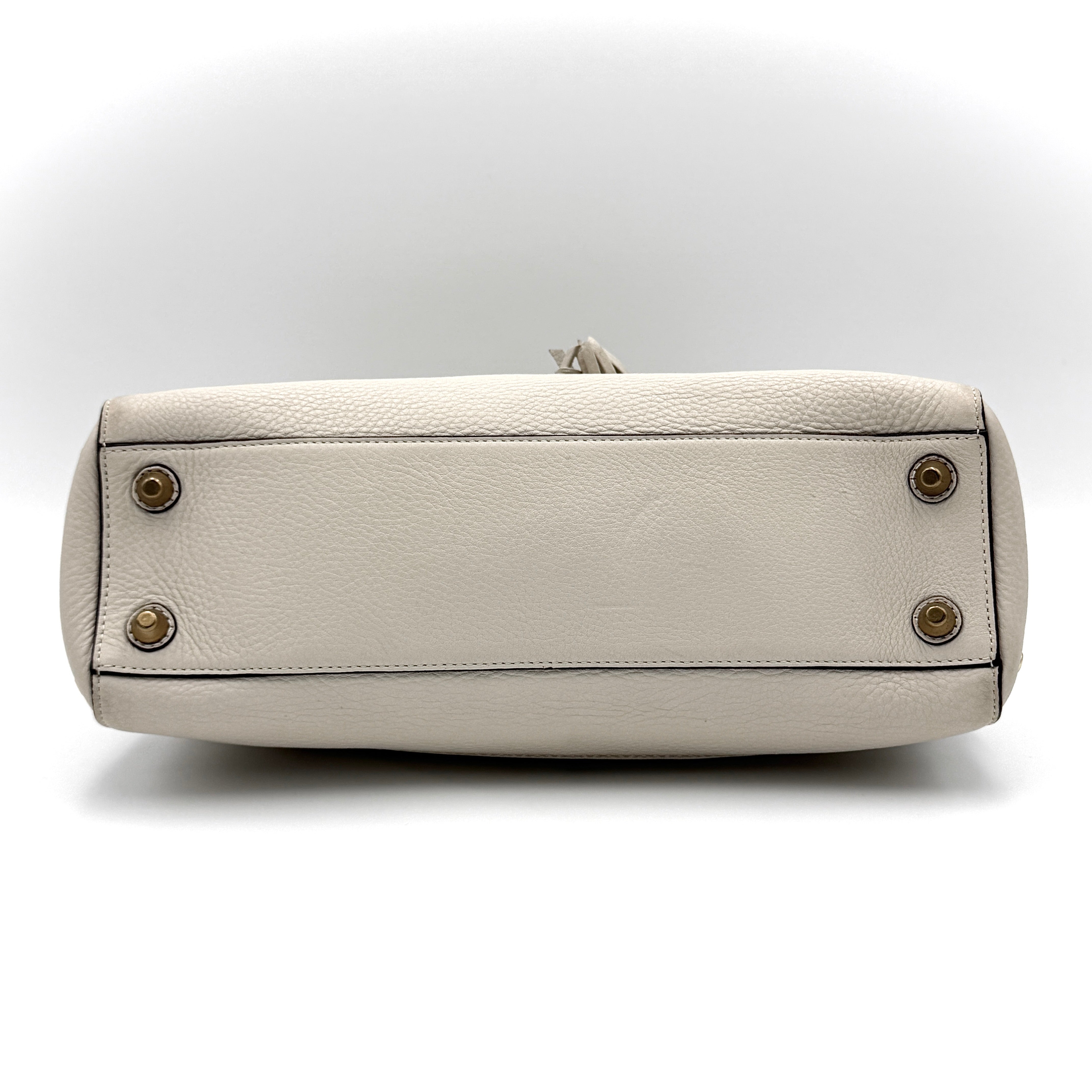 Coach Signature Hampton Carryall Shoulder Bag in ivory pebbled leather with gold-tone hardware and braided detailing, shown from the front.