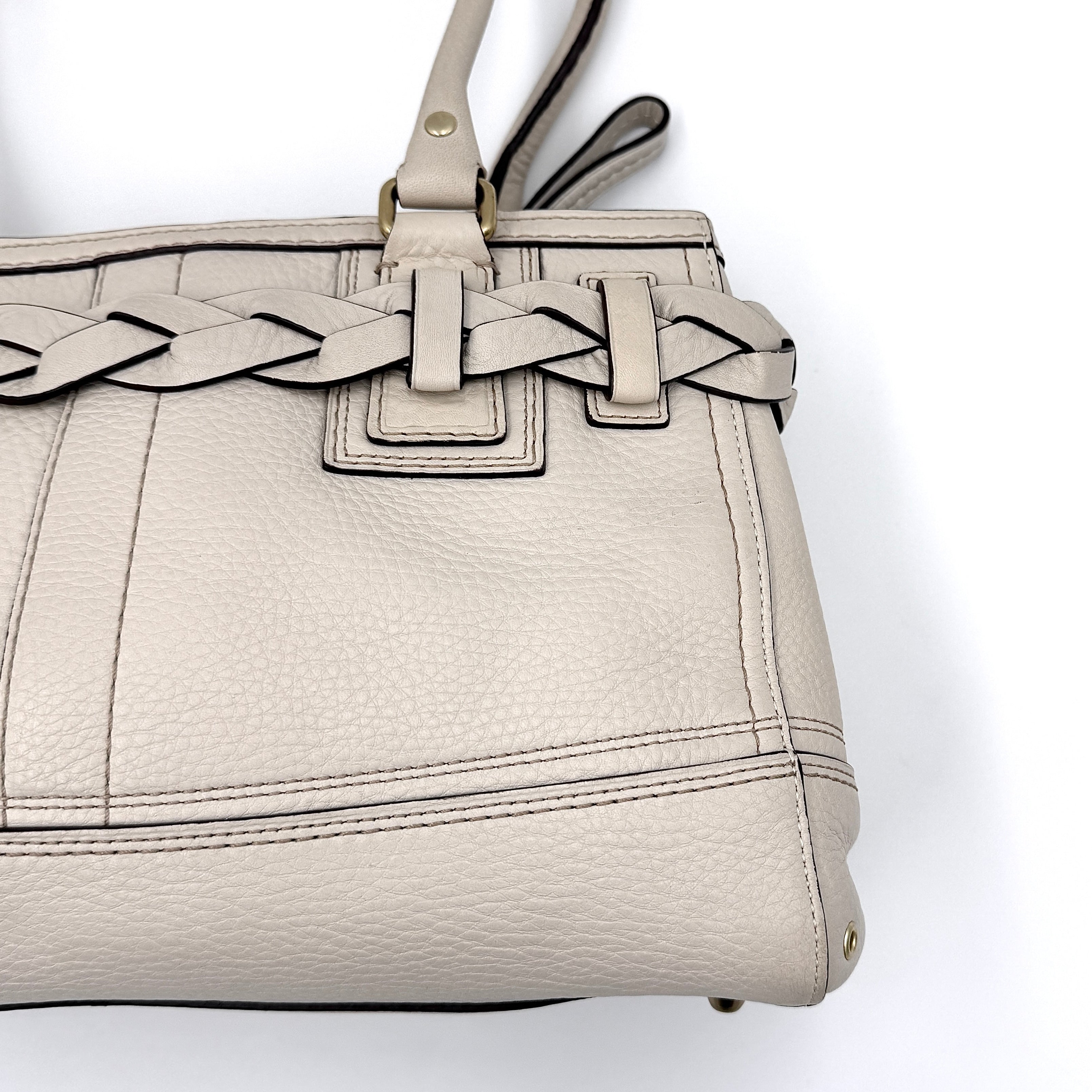 Coach Signature Hampton Carryall Shoulder Bag in ivory pebbled leather with gold-tone hardware and braided detailing, shown from the front.