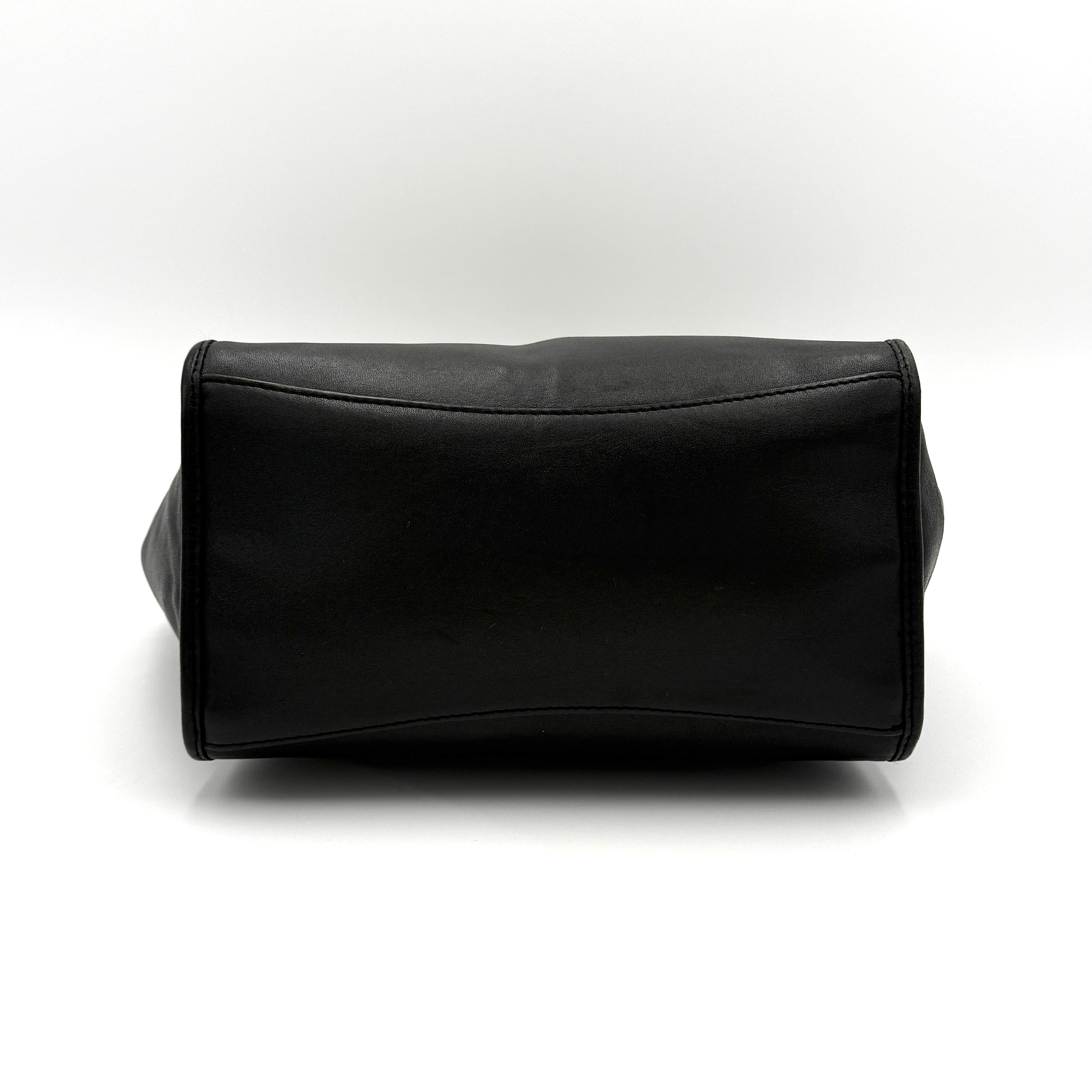 The Coach 2Way Mini Crosby Carryall Handbag in smooth black leather with gold-tone hardware, top handles, and detachable strap displayed alongside.