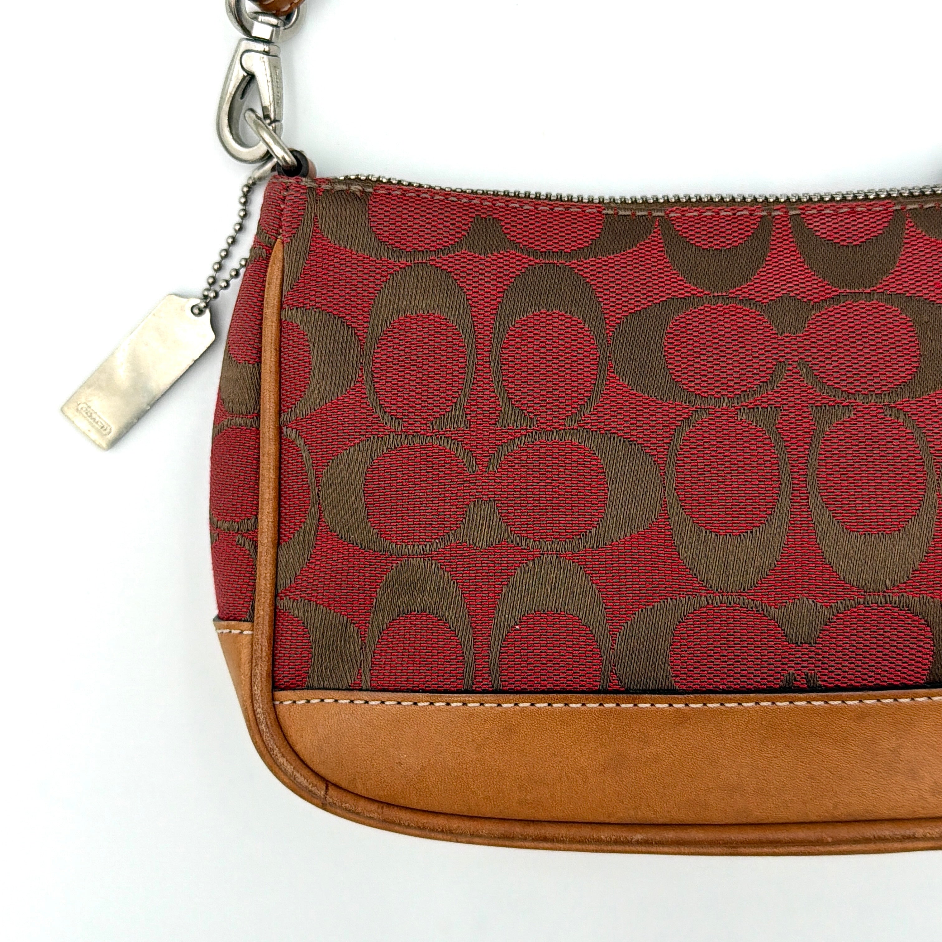 Coach Y2K Demi Shoulder Bag in red jacquard canvas with tan leather trim and silver-tone hardware, featuring a signature enamel Coach hangtag.