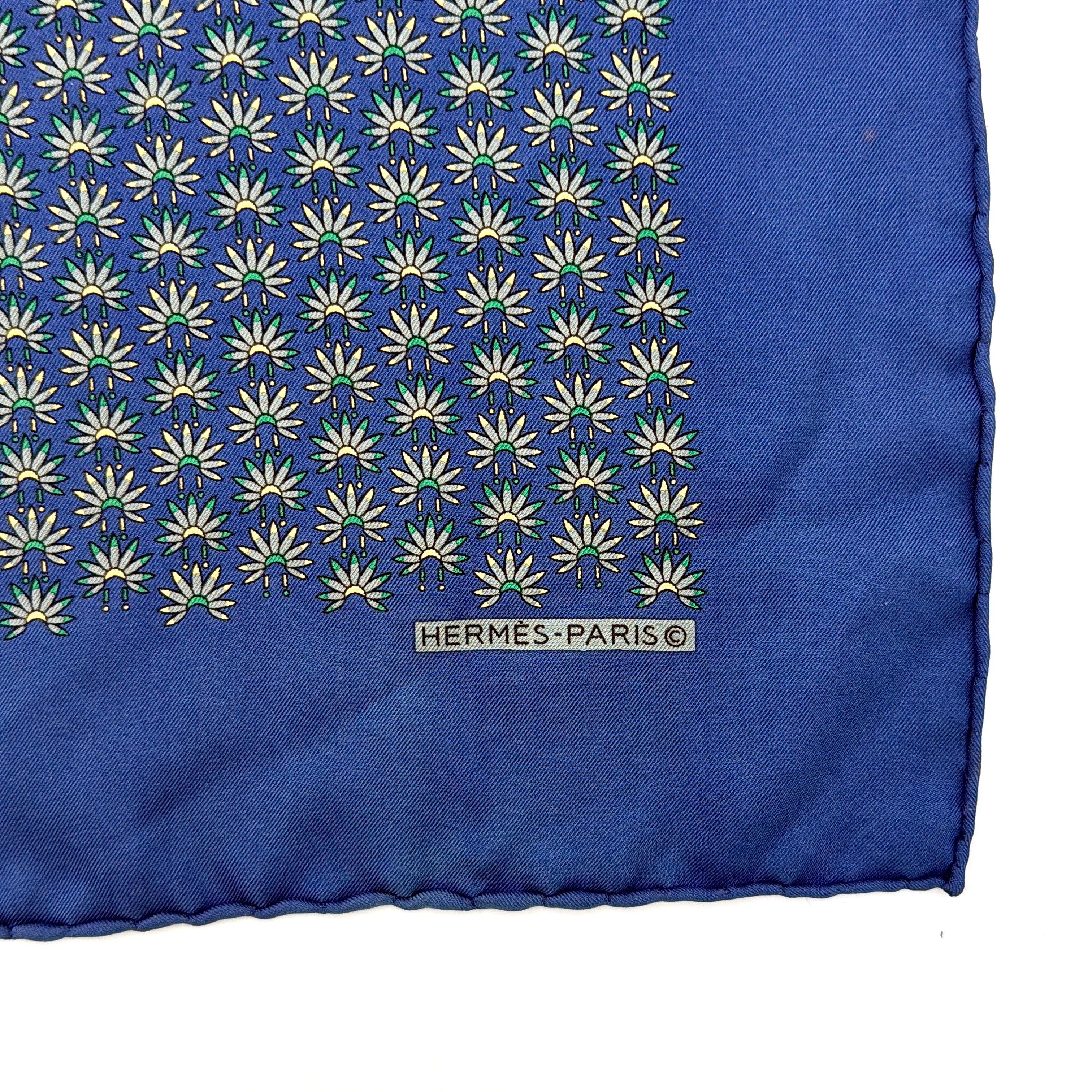 Hermès silk scarf in vibrant blue, featuring a precise all-over floral pattern and hand-rolled edges.