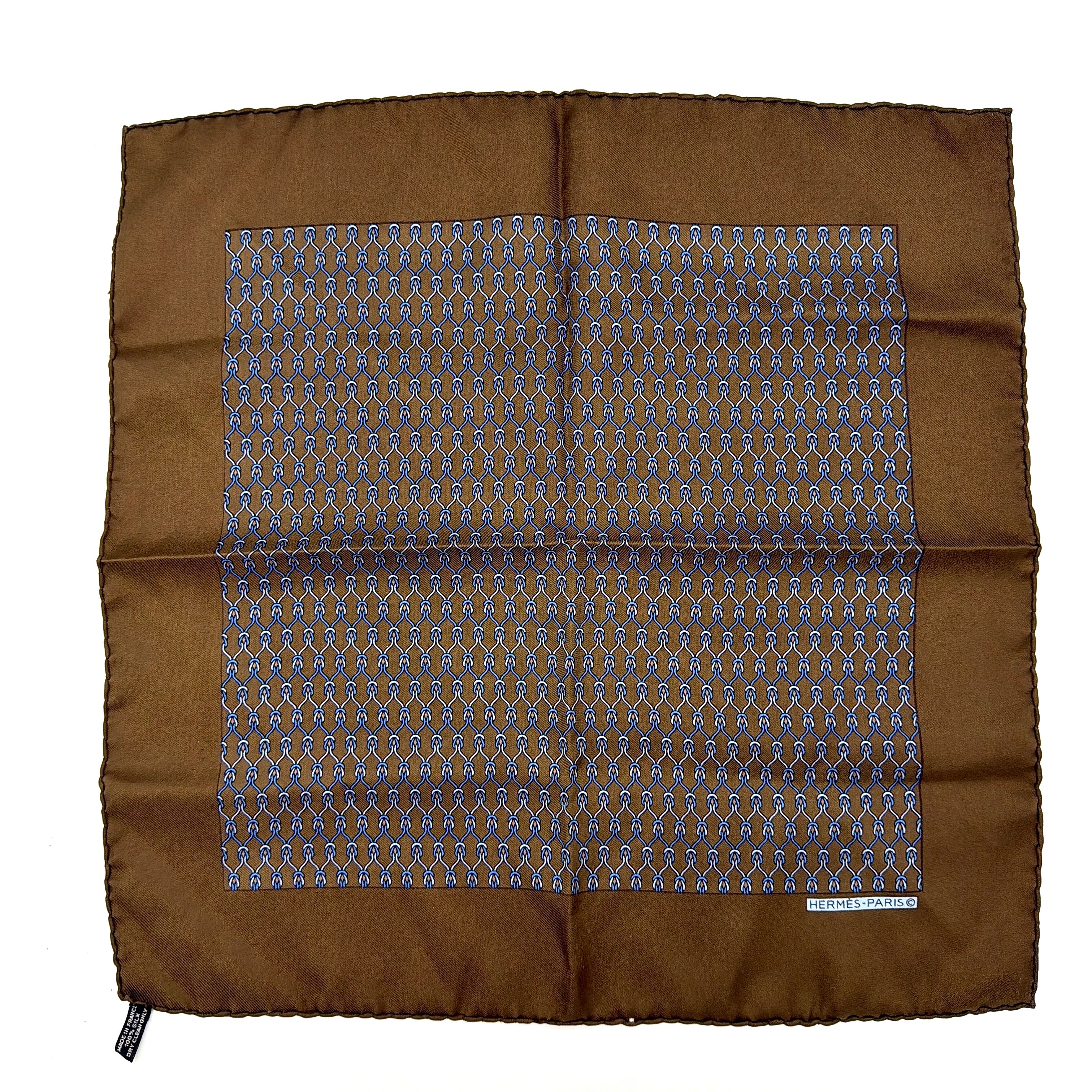 Hermès brown silk scarf featuring a blue and white chain link pattern, finished with elegant rolled edges.