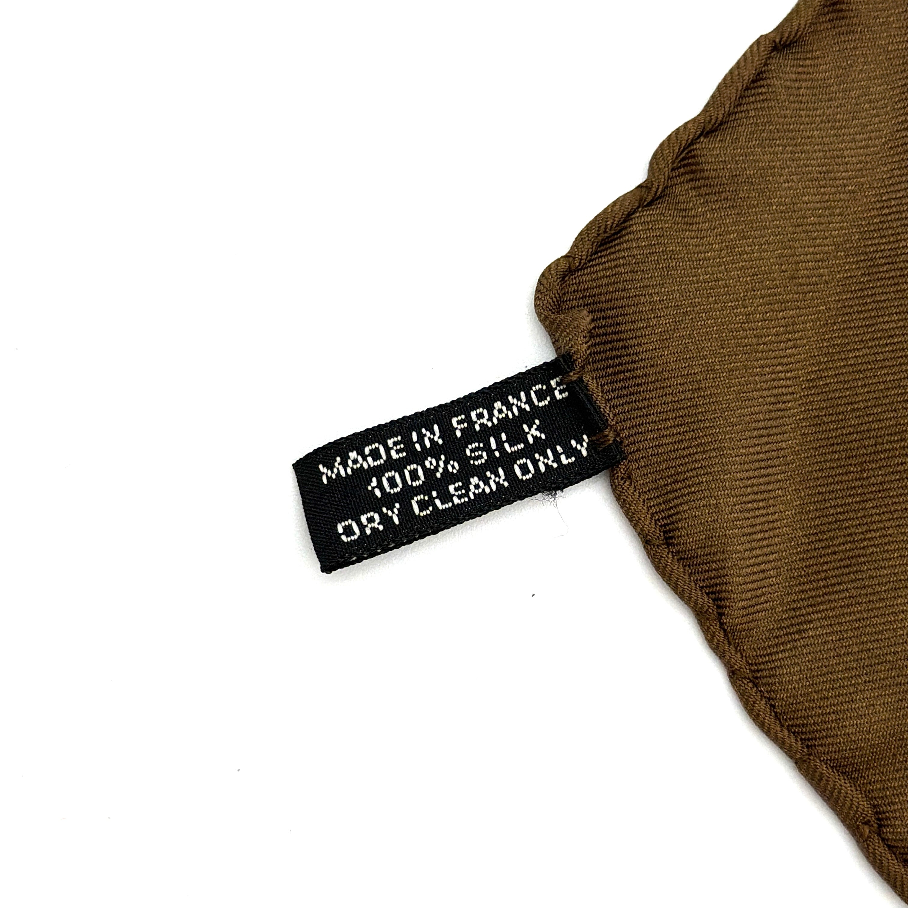 Hermès brown silk scarf featuring a blue and white chain link pattern, finished with elegant rolled edges.