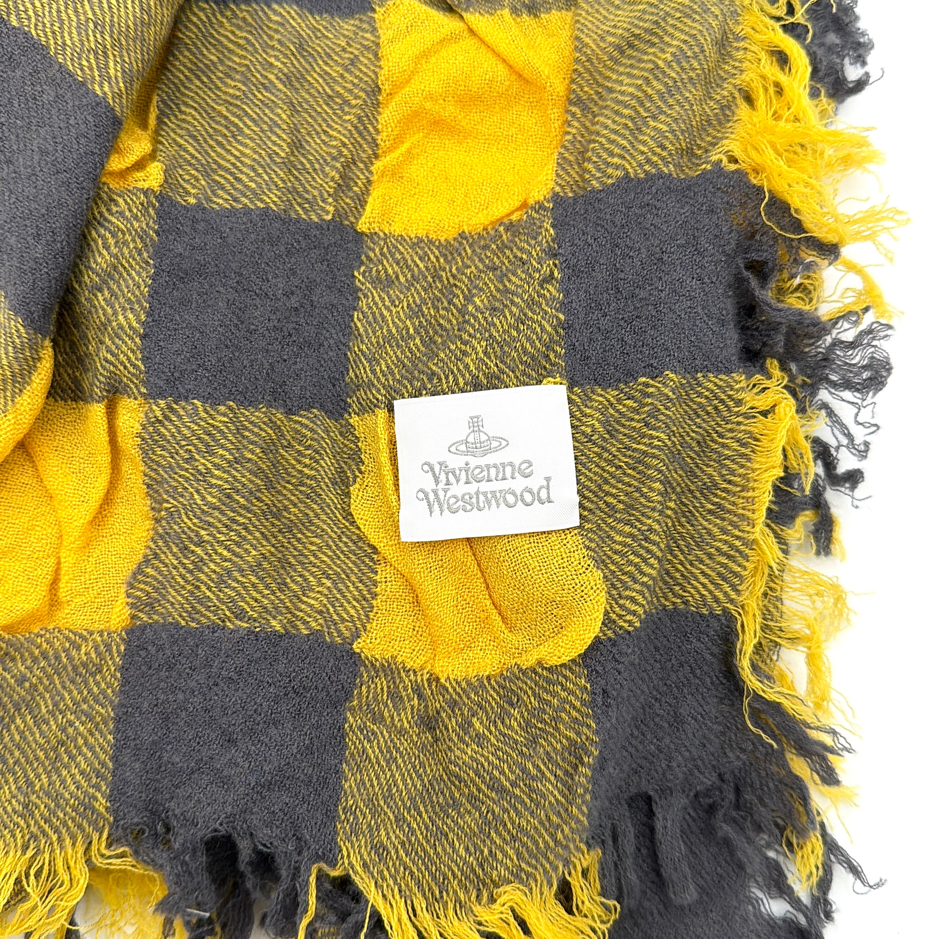 Vivienne Westwood yellow and grey check scarf with fringed edges and signature orb embroidery, artfully draped.