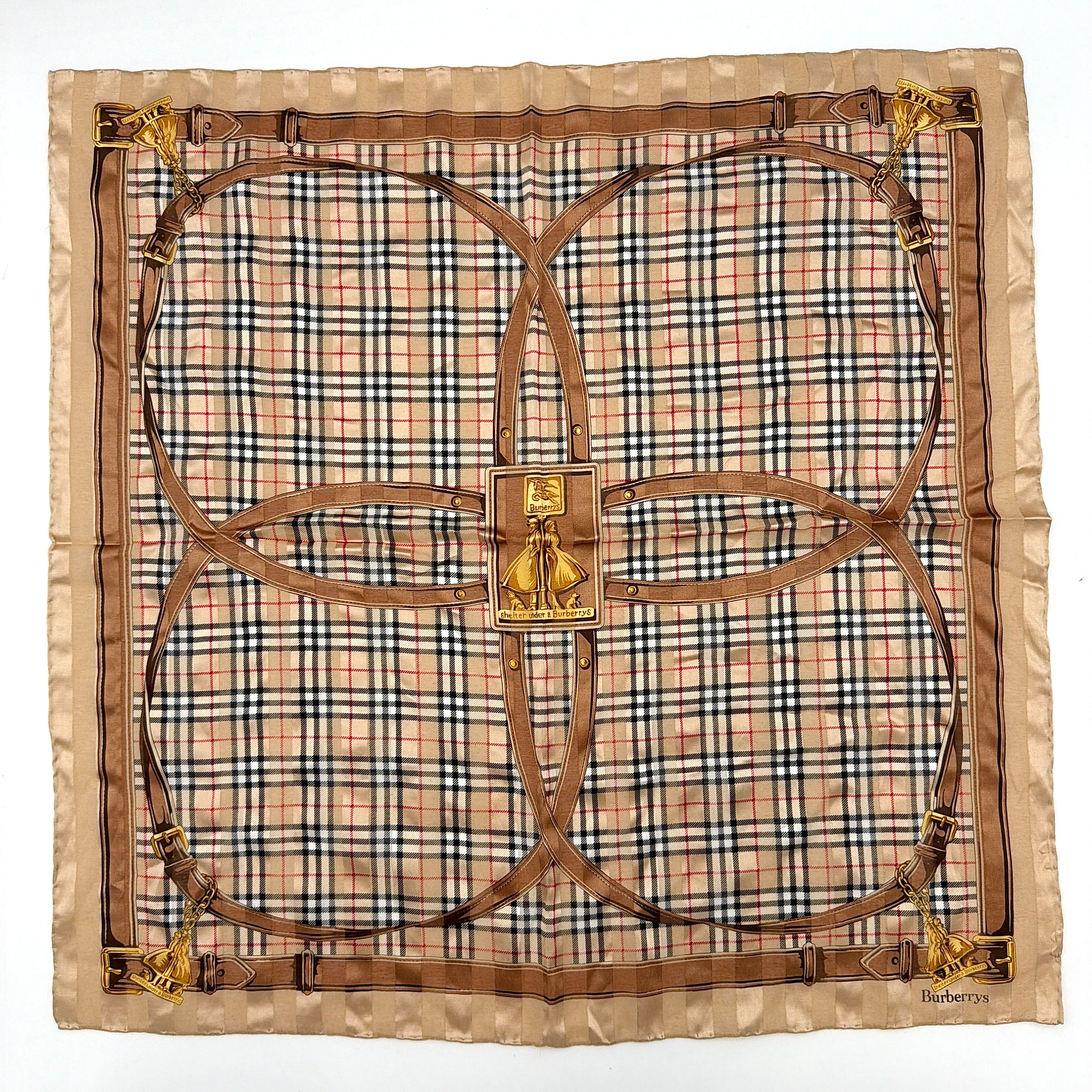 Editorial image of a Burberry silk bandana featuring Nova Check and equestrian-inspired harness motif in beige and gold tones.