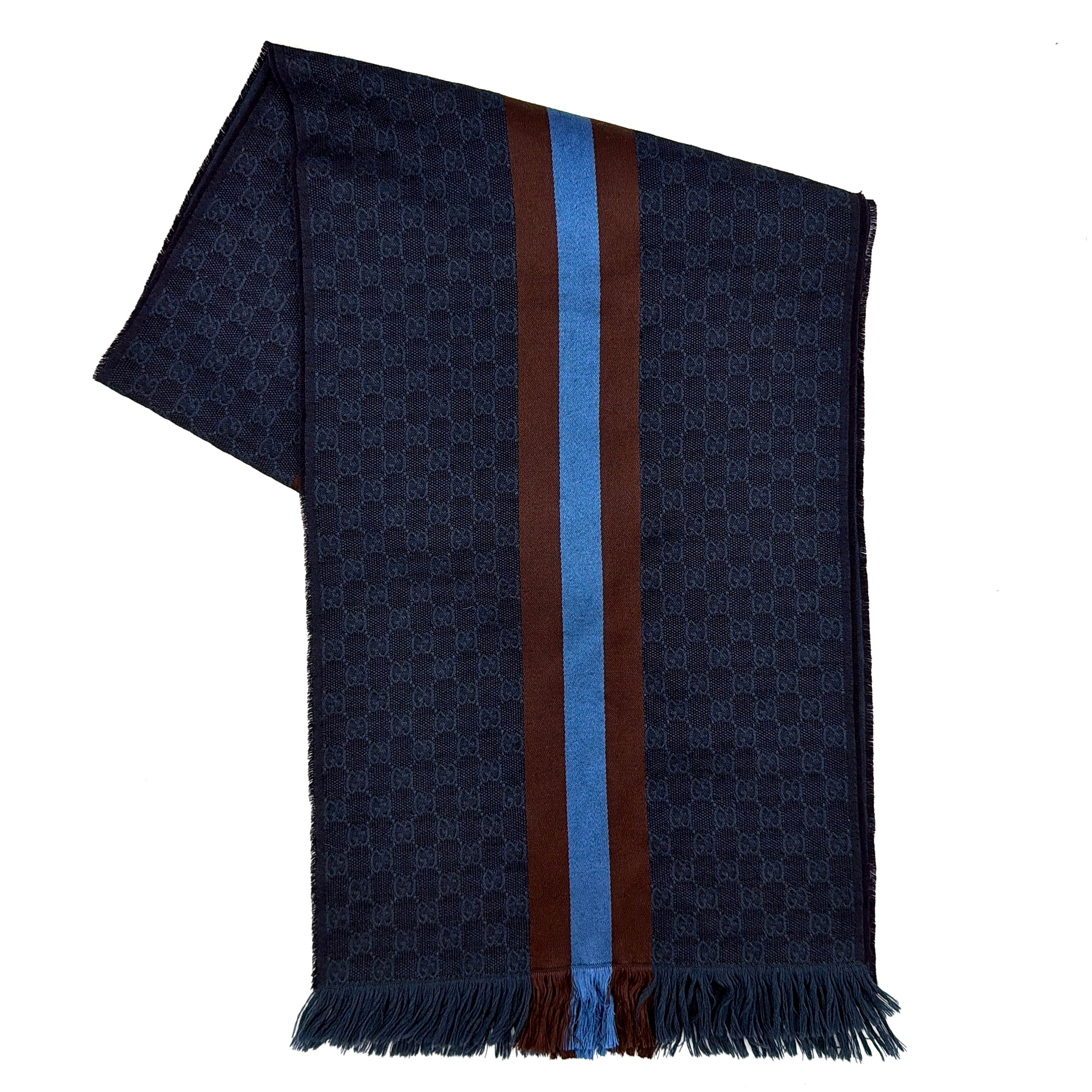 Gucci GG Monogram navy blue scarf with brown and blue Sherry Web stripes and fringed edges, artfully arranged to showcase its luxurious texture.