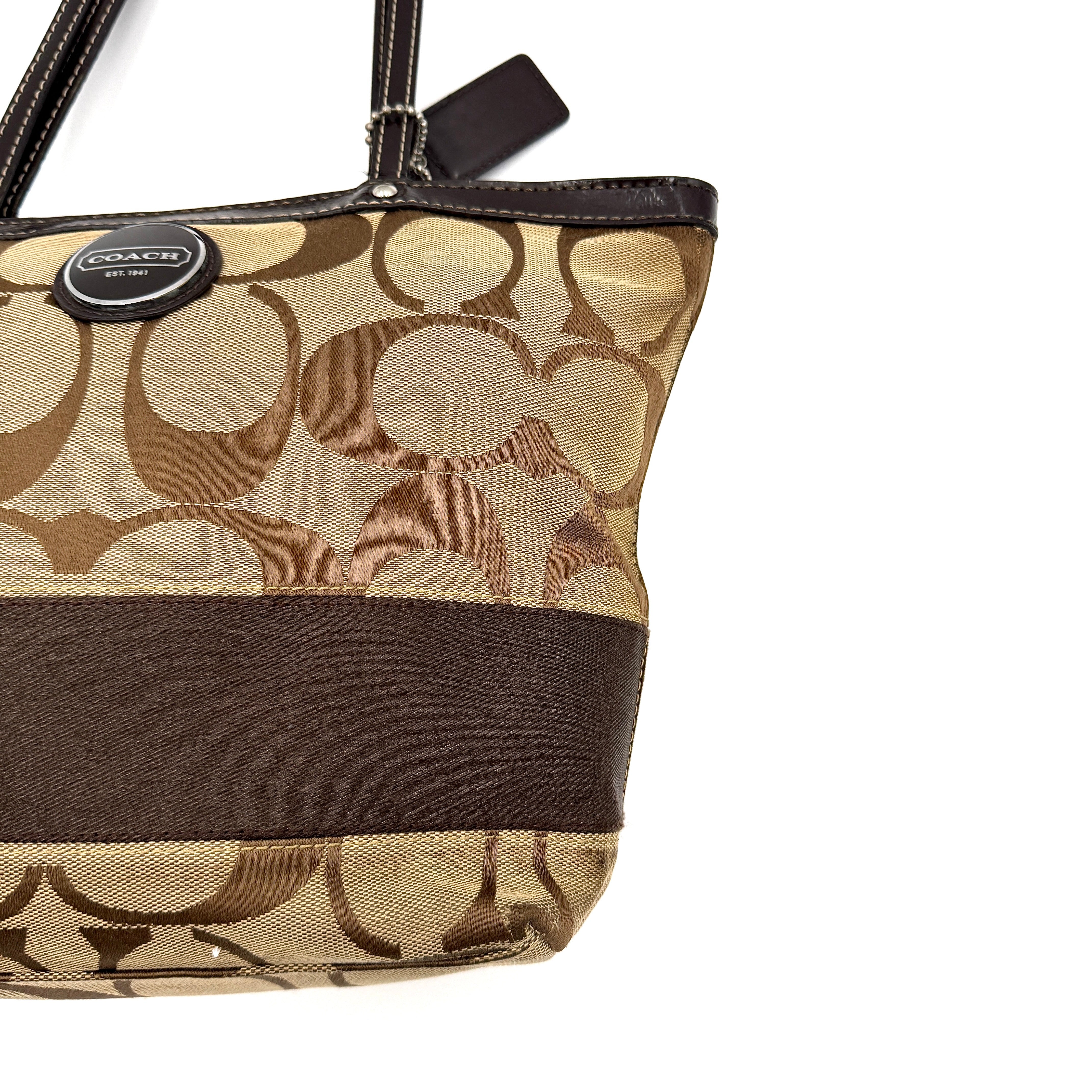 Coach Signature Stripe Tote Bag in beige and brown with bold monogram canvas, leather trim, and dual shoulder straps.