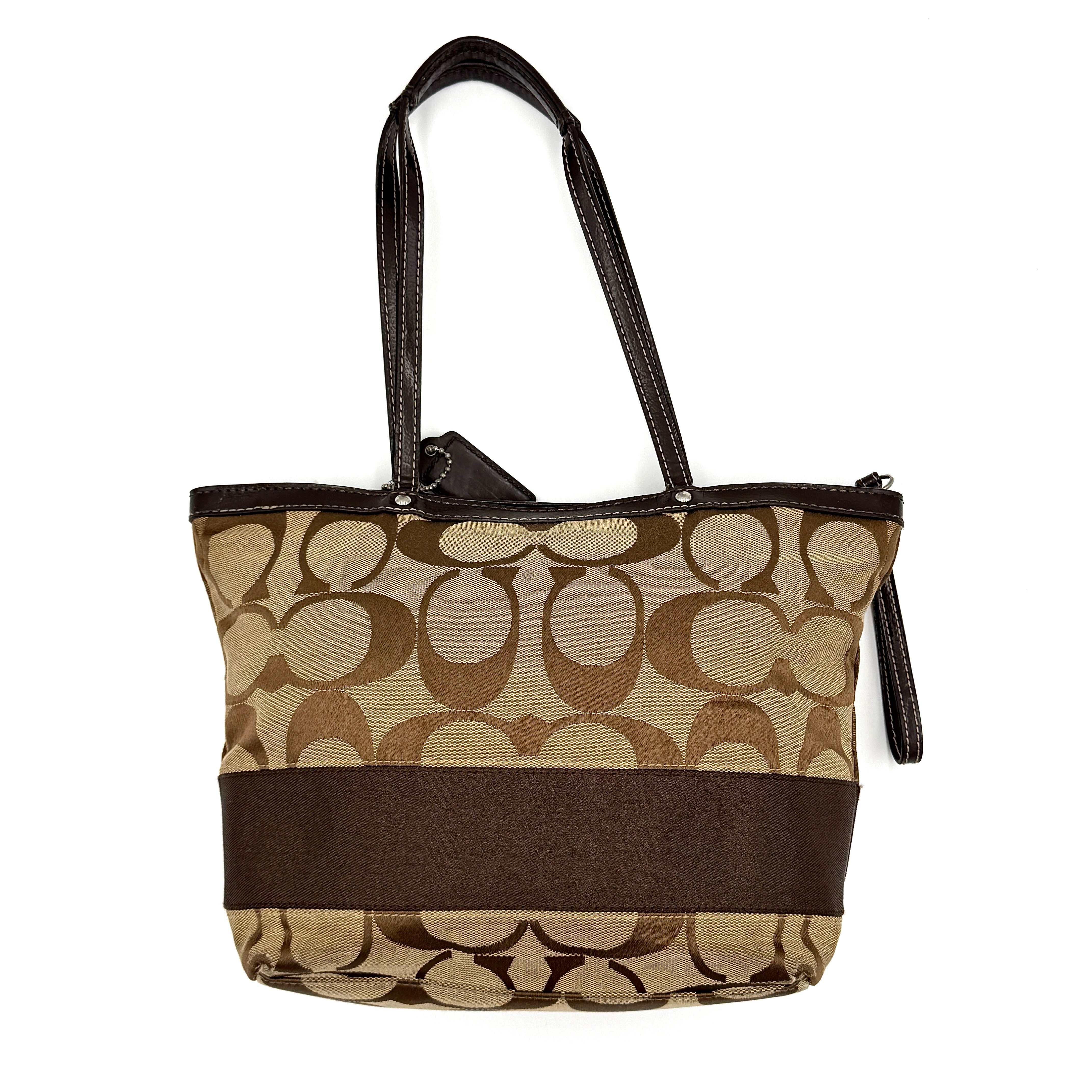 Coach Signature Stripe Tote Bag in beige and brown with bold monogram canvas, leather trim, and dual shoulder straps.