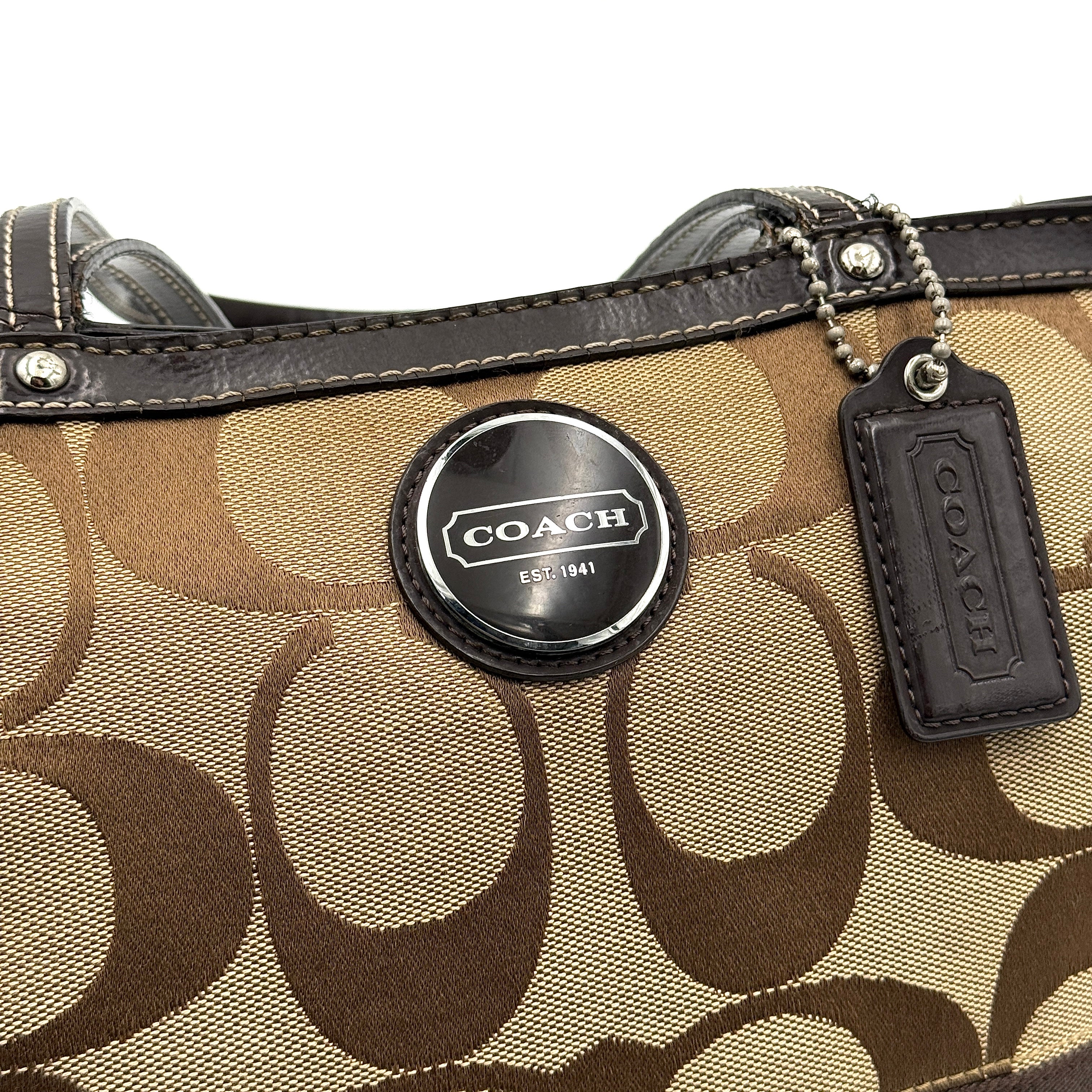 Coach Signature Stripe Tote Bag in beige and brown with bold monogram canvas, leather trim, and dual shoulder straps.