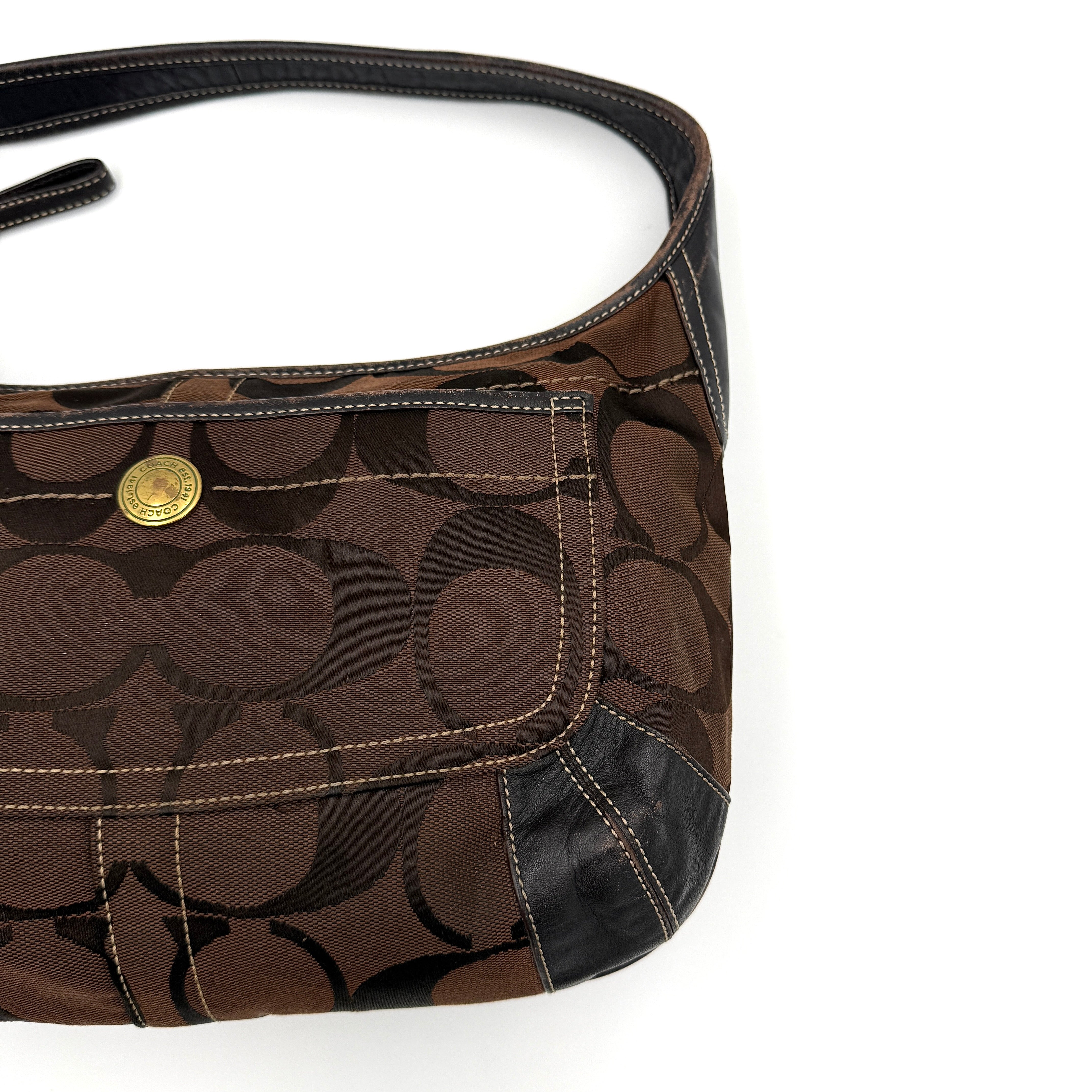 Coach Signature Ergo Hobo Shoulder Bag in brown monogram canvas with dark leather trim and gold-tone hardware, shown from the front.