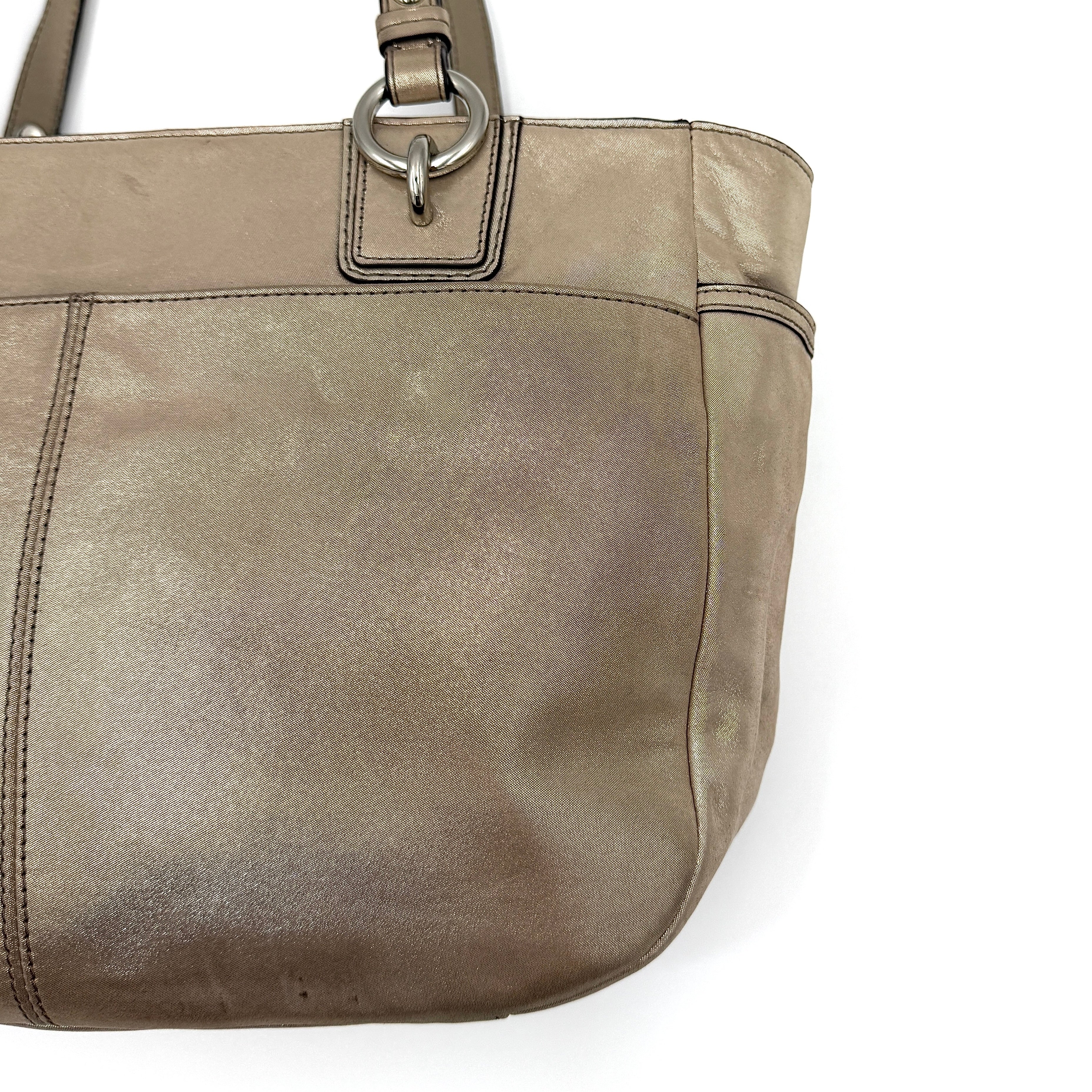 Coach Shimmer Gallery Tote in metallic beige leather with silver-tone hardware and dual top handles, set against a white background.