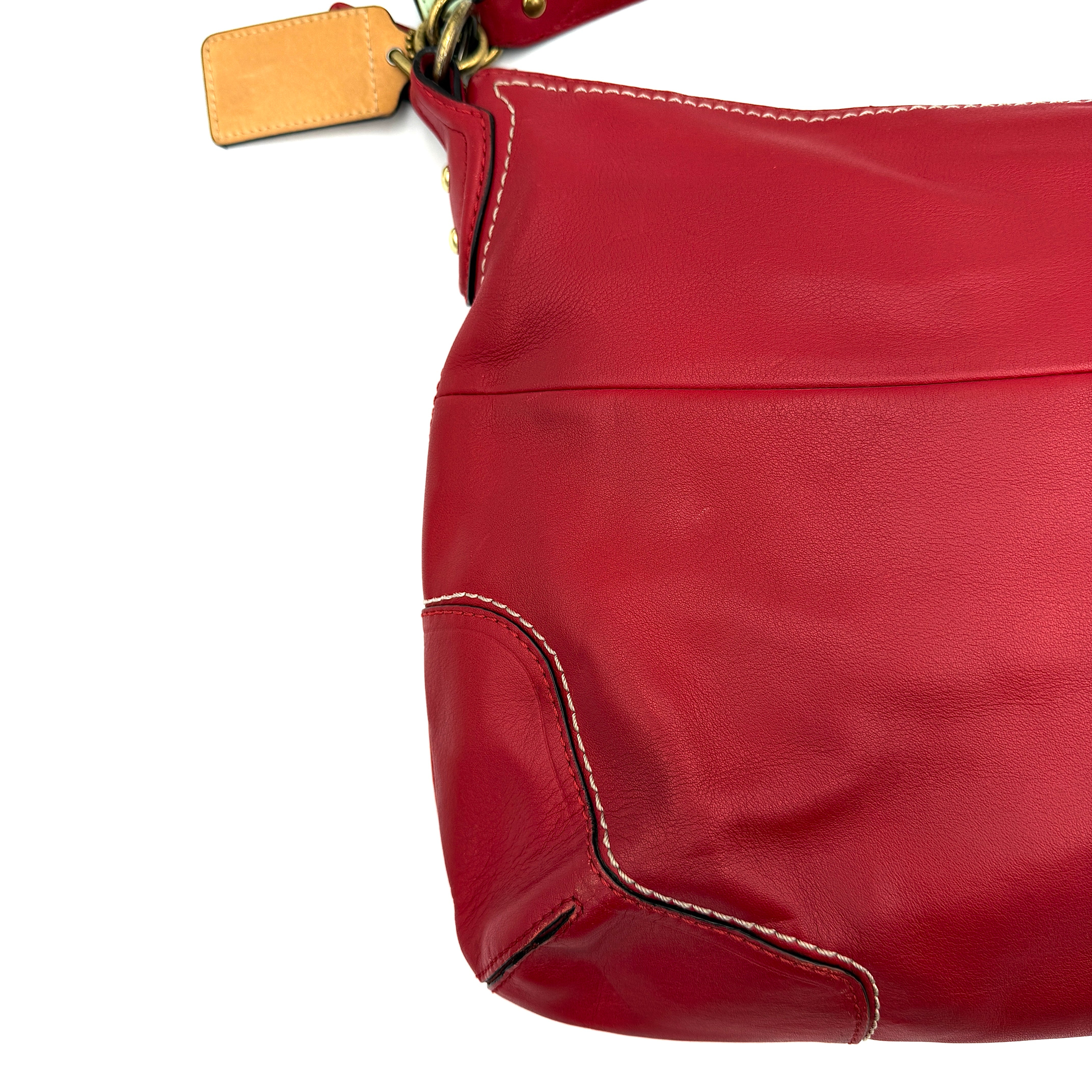 Coach Ashley Double Pocket Hobo in vibrant red leather, featuring distinctive front pockets, gold-tone hardware, and signature Coach hangtags.