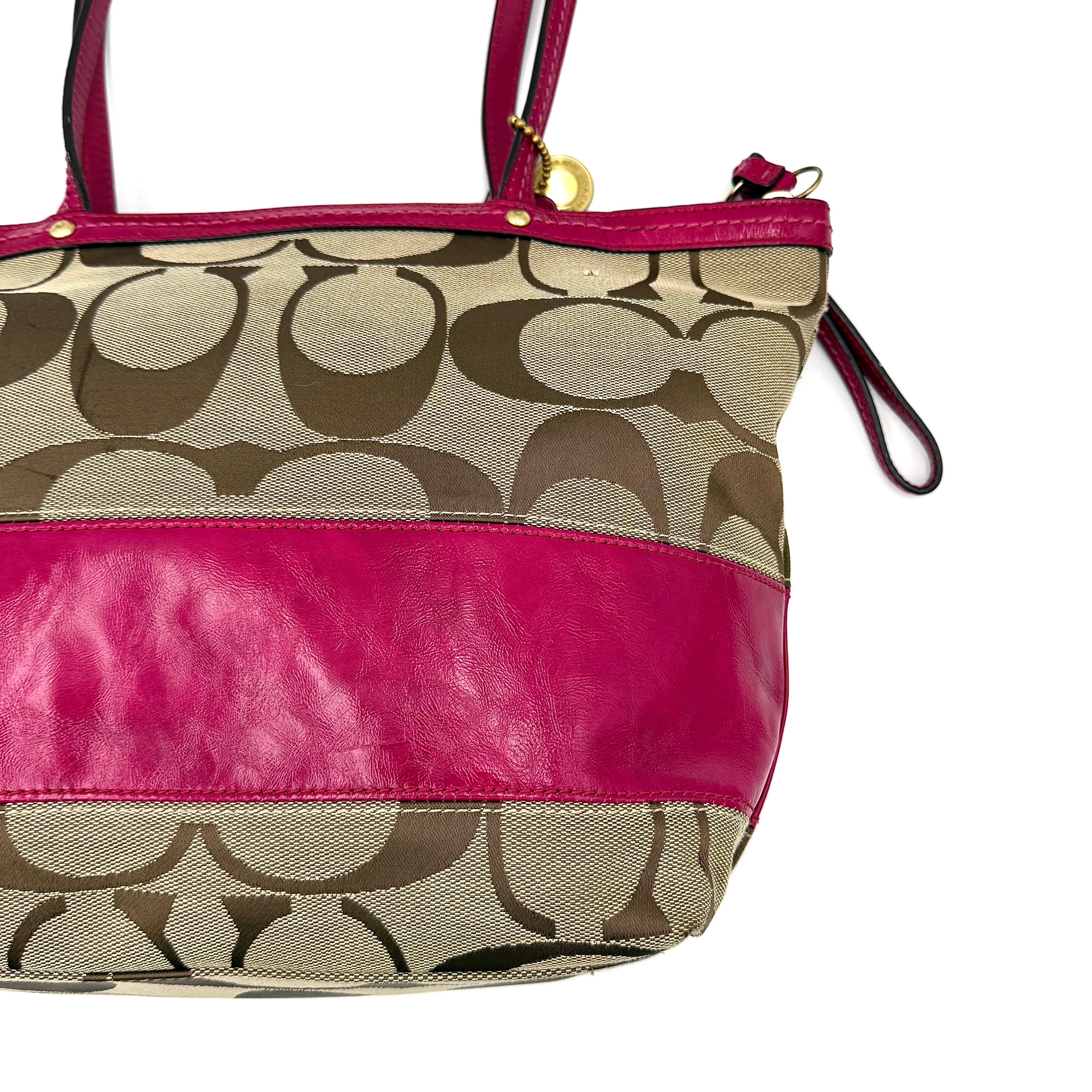 Coach Signature Stripe Tote Bag in beige monogram canvas with bold pink leather accents and top handles.
