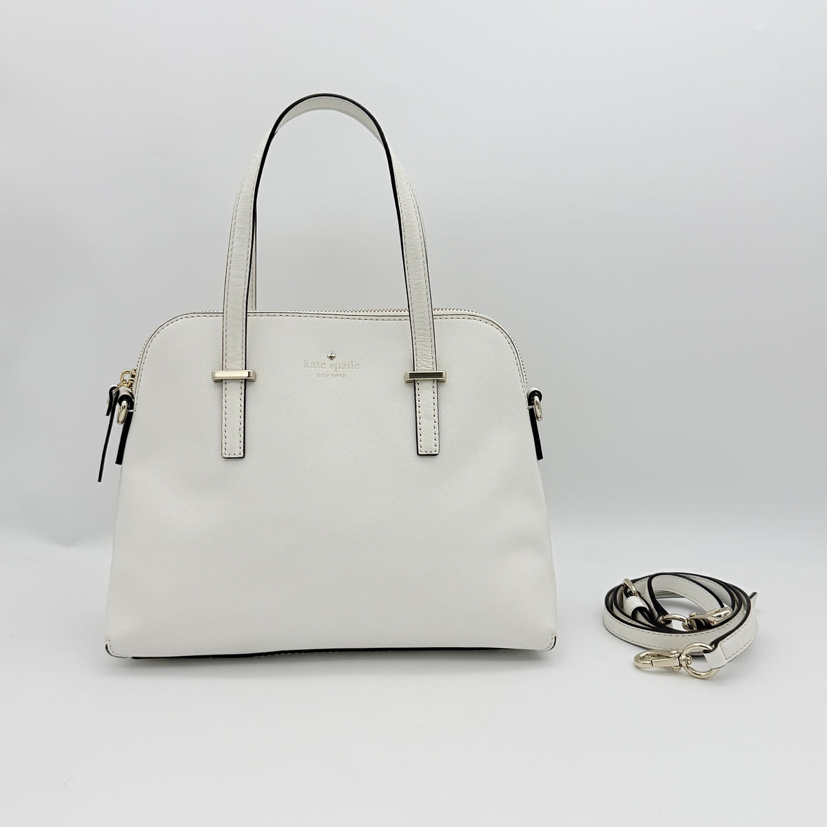 Top view of the Kate Spade Cedar Street Maise satchel in ivory, showing its spacious polka dot interior and zip pocket detail.