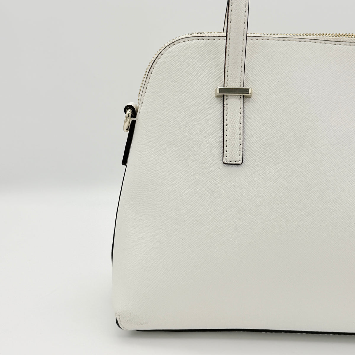Top view of the Kate Spade Cedar Street Maise satchel in ivory, showing its spacious polka dot interior and zip pocket detail.
