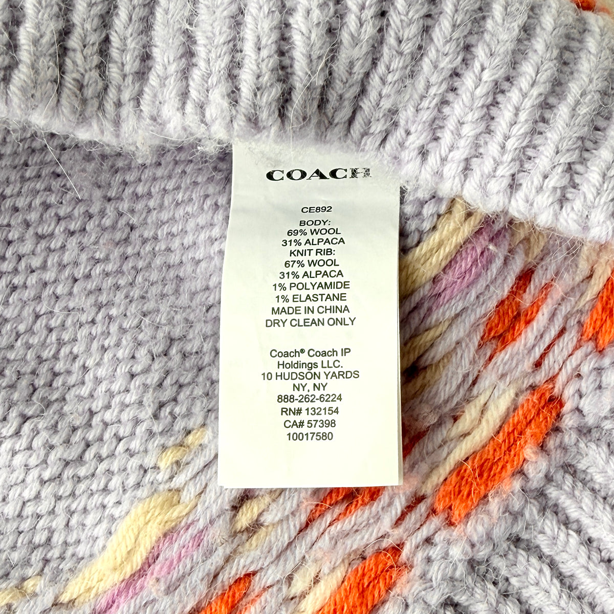 Coach Fair Isle Ski Sweater in lilac with orange and cream geometric pattern and COACH logo across the chest.