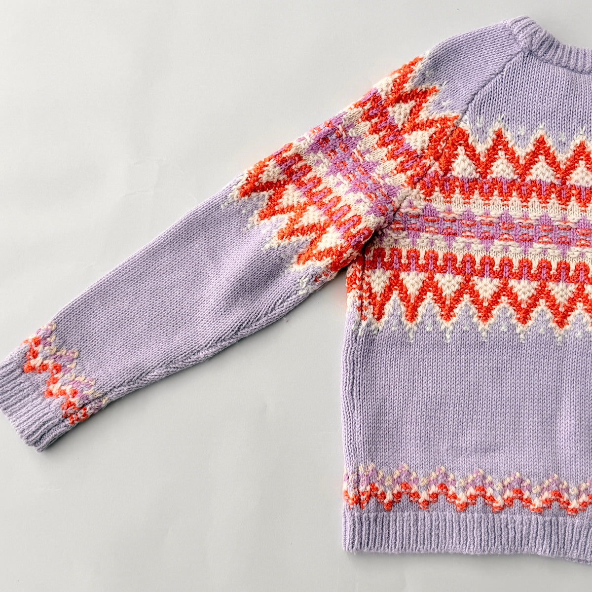 Coach Fair Isle Ski Sweater in lilac with orange and cream geometric pattern and COACH logo across the chest.