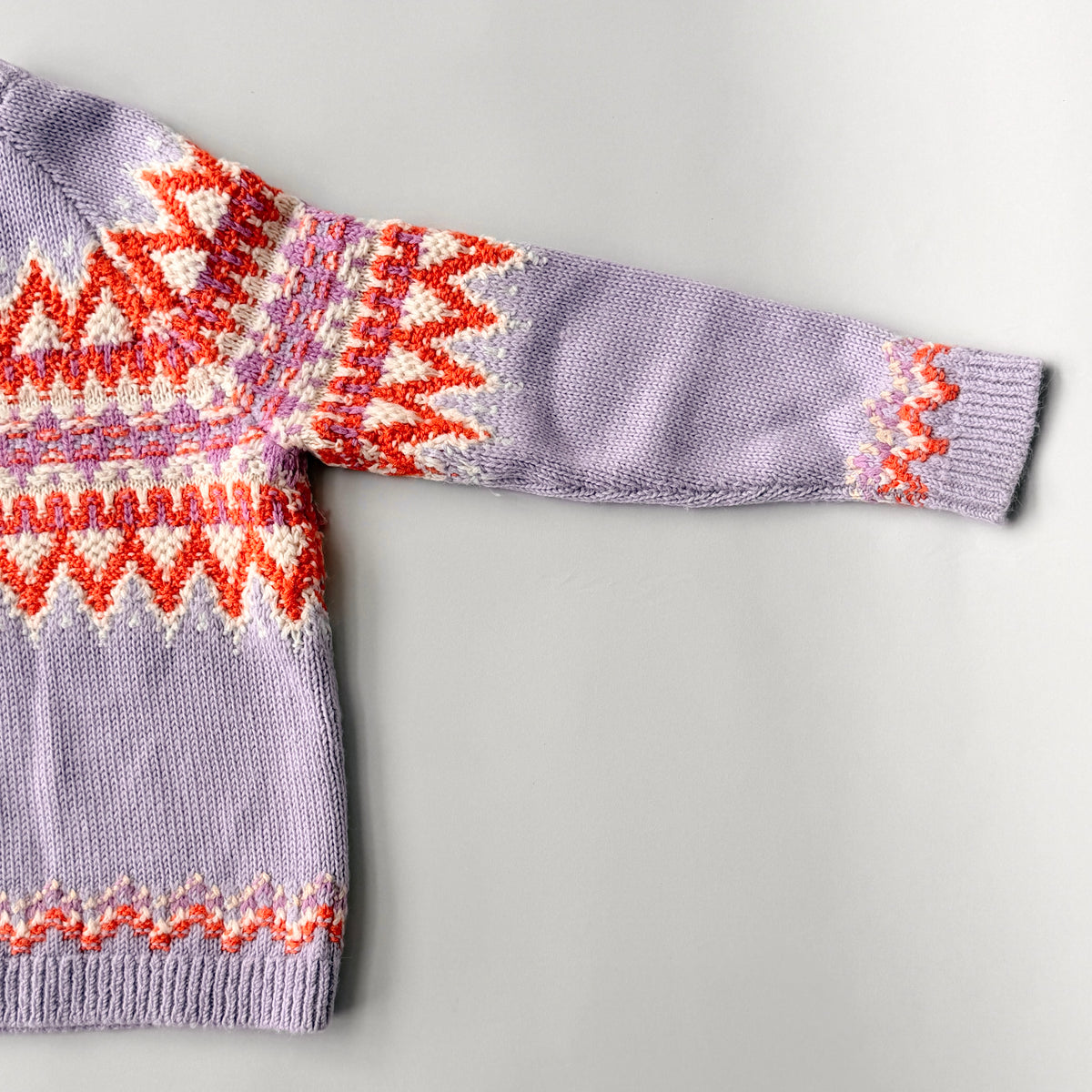 Coach Fair Isle Ski Sweater in lilac with orange and cream geometric pattern and COACH logo across the chest.