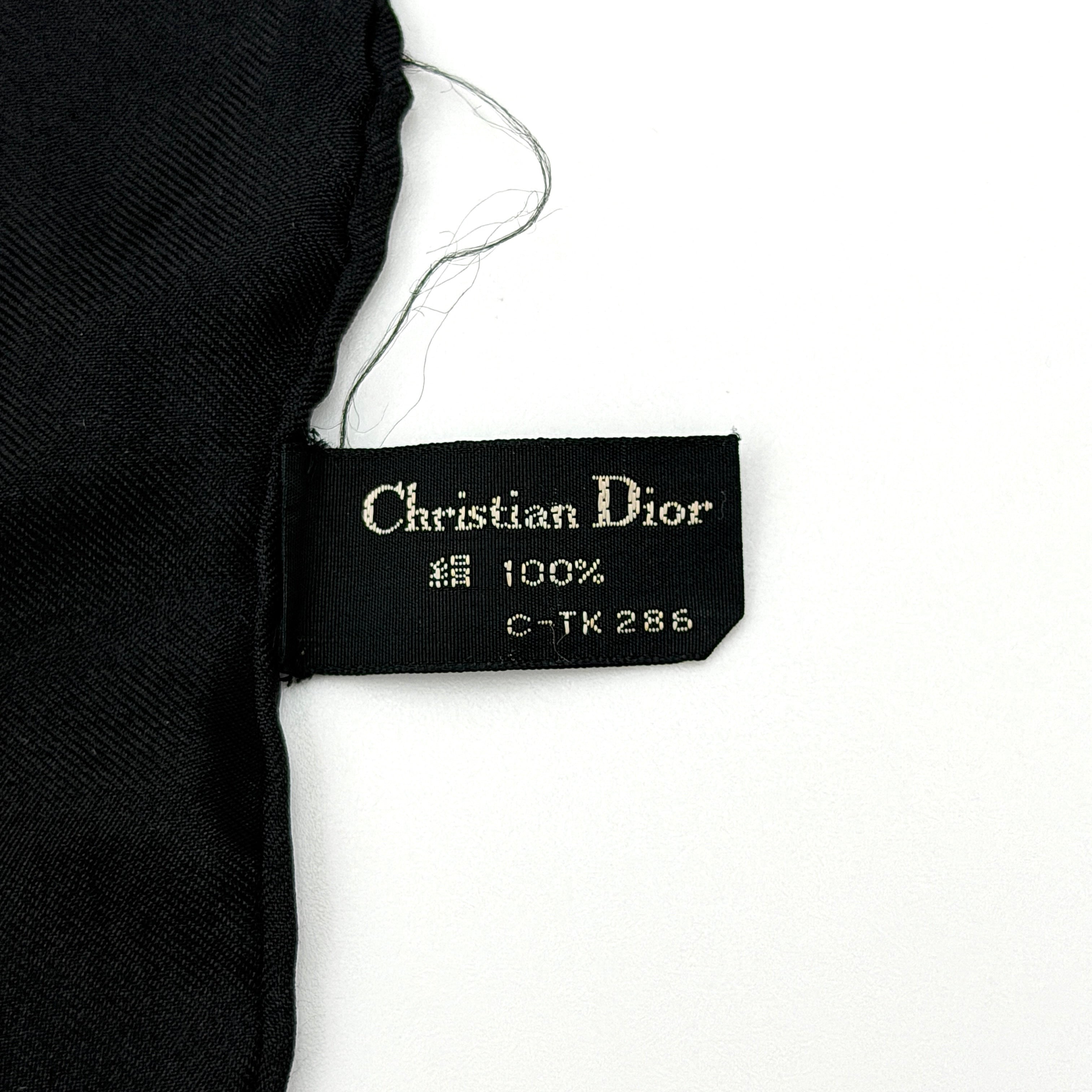 Dior monogram silk scarf in black and cream with graphic logo pattern and bold black border.