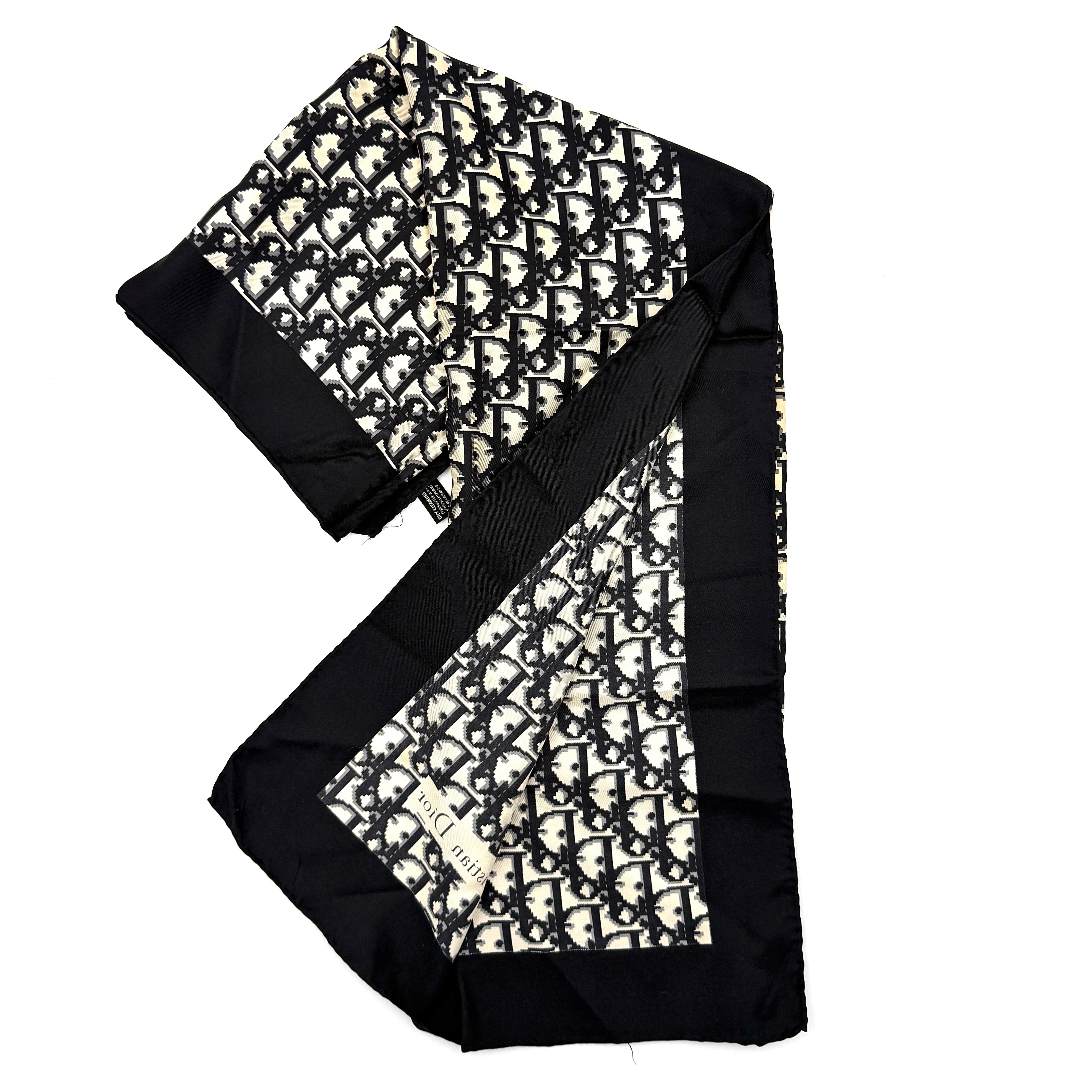 Dior monogram silk scarf in black and cream with graphic logo pattern and bold black border.