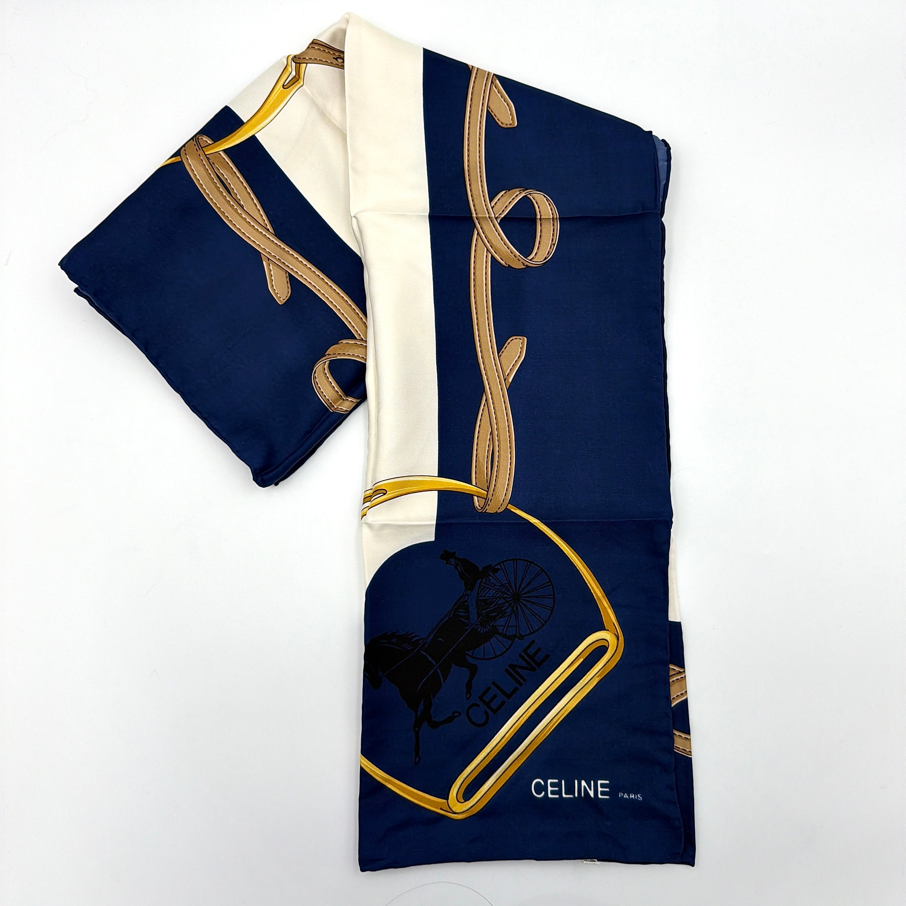 Celine silk scarf in navy blue with equestrian-inspired yellow and tan rein motif and carriage logo on silk.