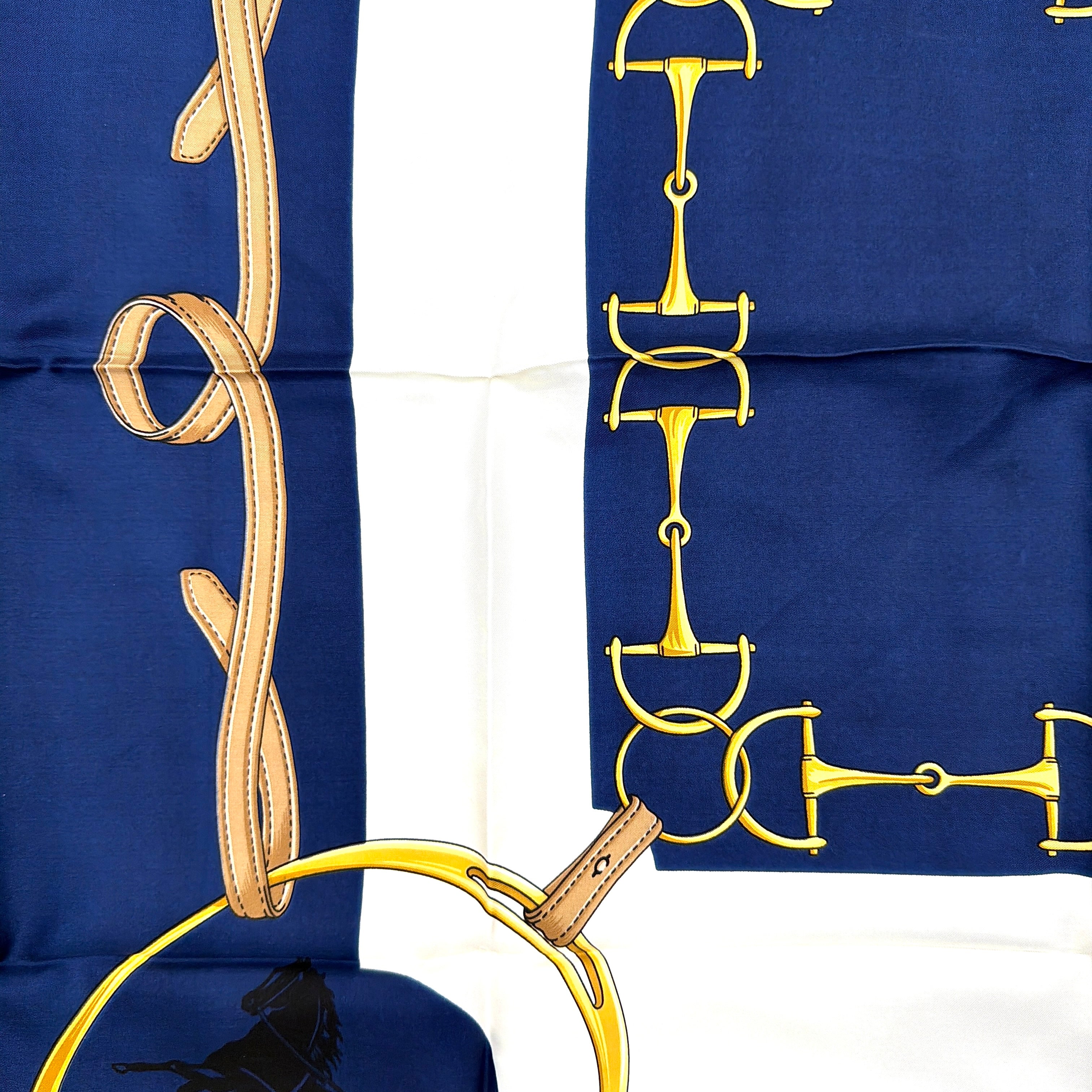 Celine silk scarf in navy blue with equestrian-inspired yellow and tan rein motif and carriage logo on silk.