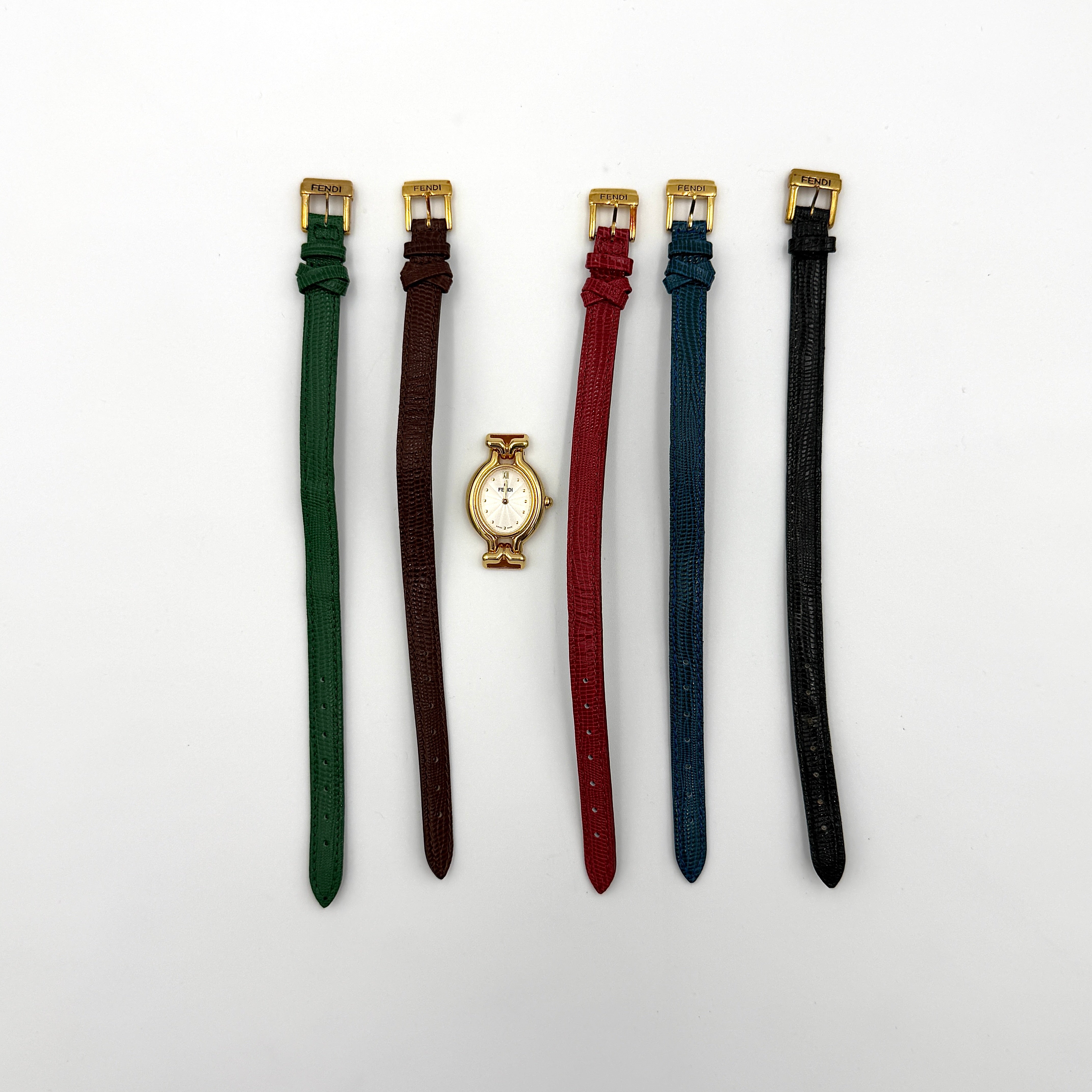 Fendi 640L Chameleon watch with five colored leather straps and gold-tone case displayed in a row.
