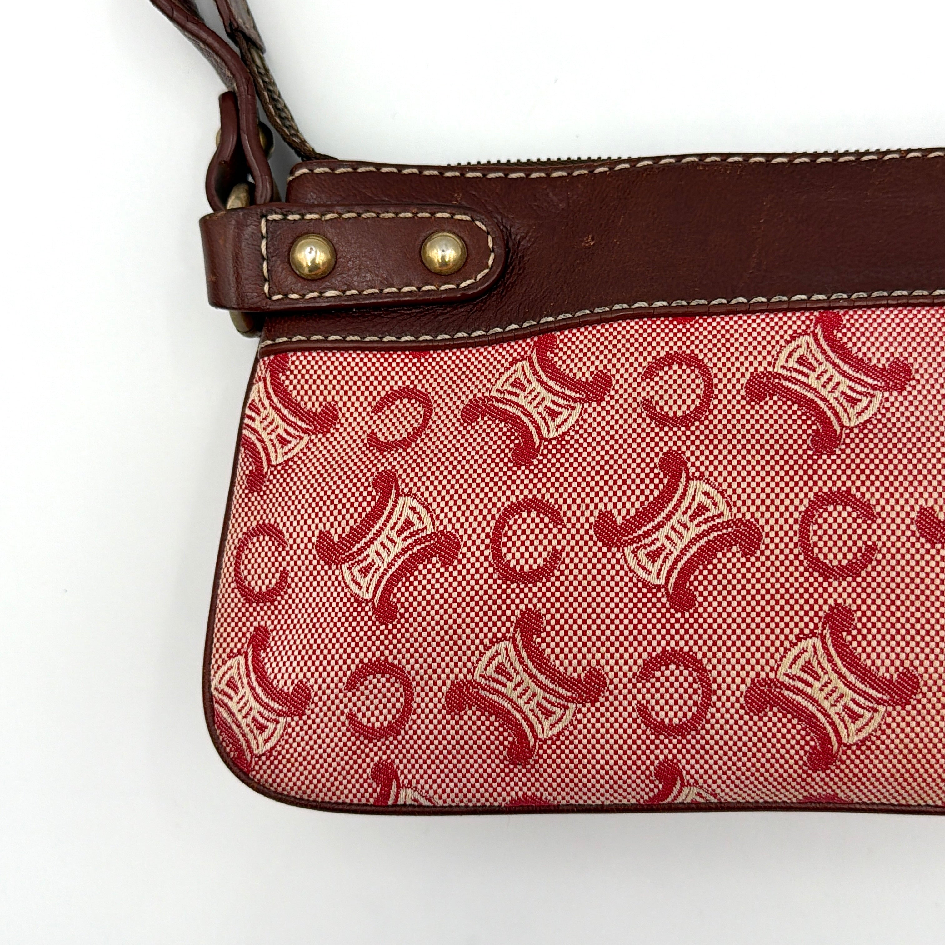 Celine Macadam shoulder bag in red coated canvas with brown leather trim and gold-tone hardware.