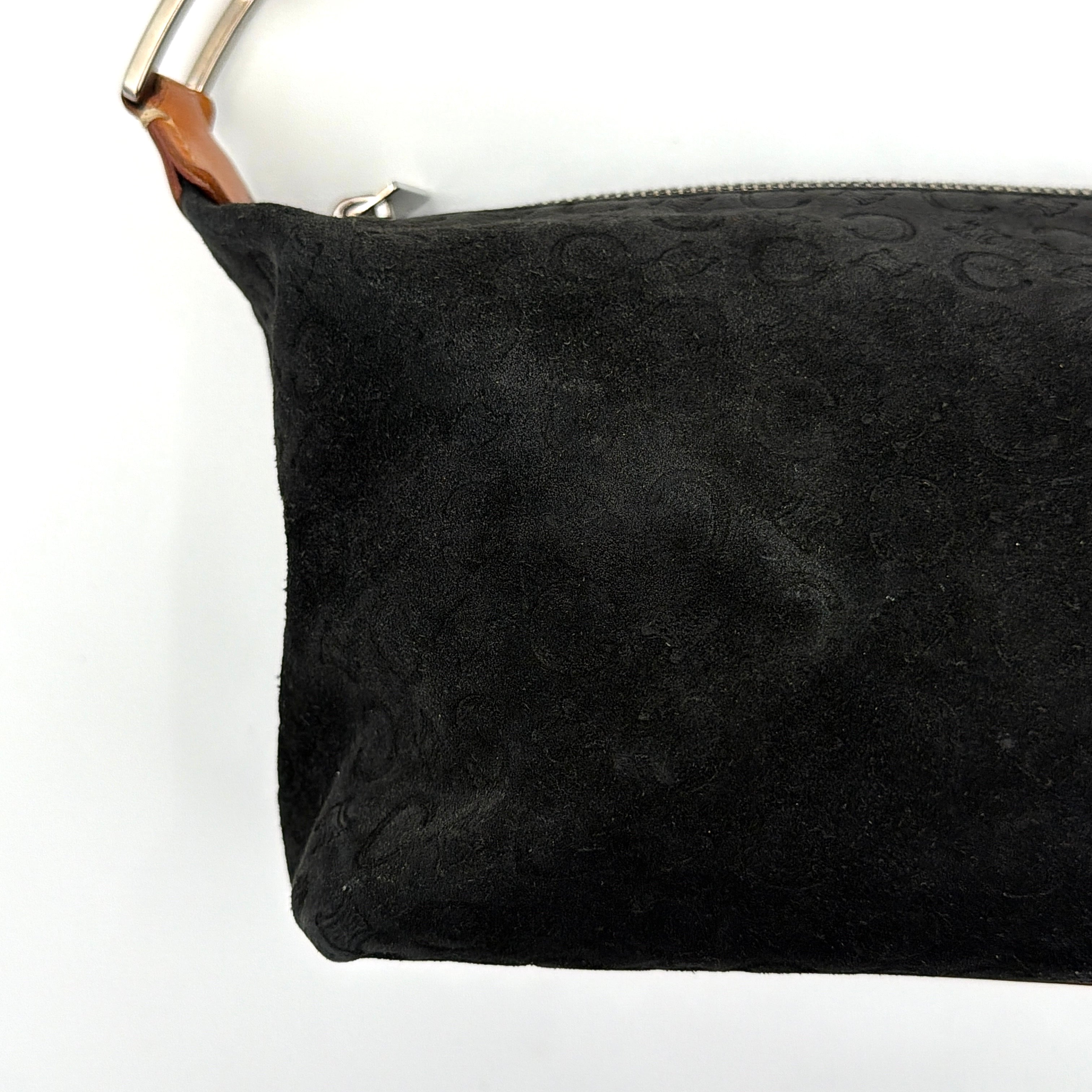 Celine black suede shoulder bag with embossed Triomphe motif, tan leather strap and silver-tone hardware, displayed from the front.