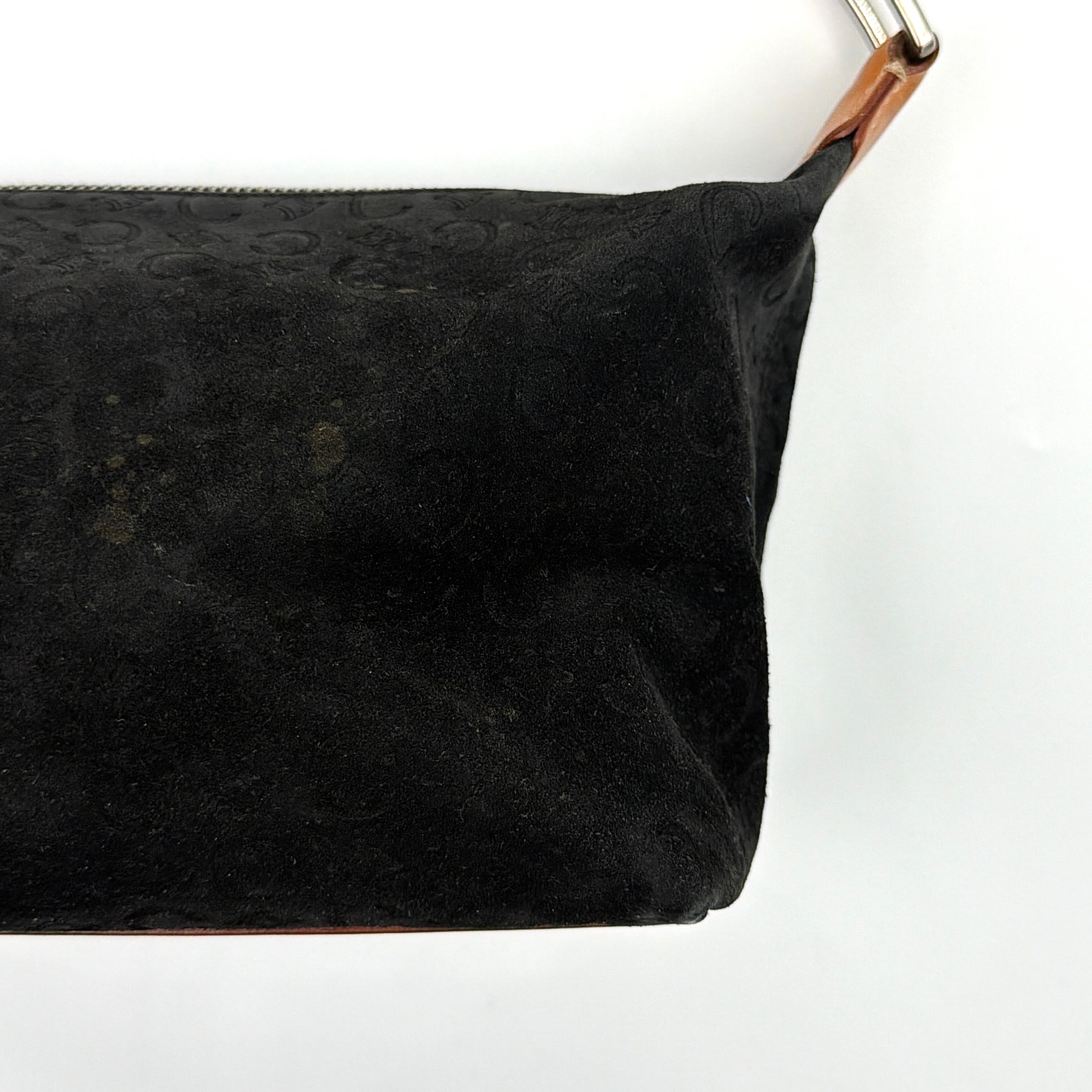 Celine black suede shoulder bag with embossed Triomphe motif, tan leather strap and silver-tone hardware, displayed from the front.