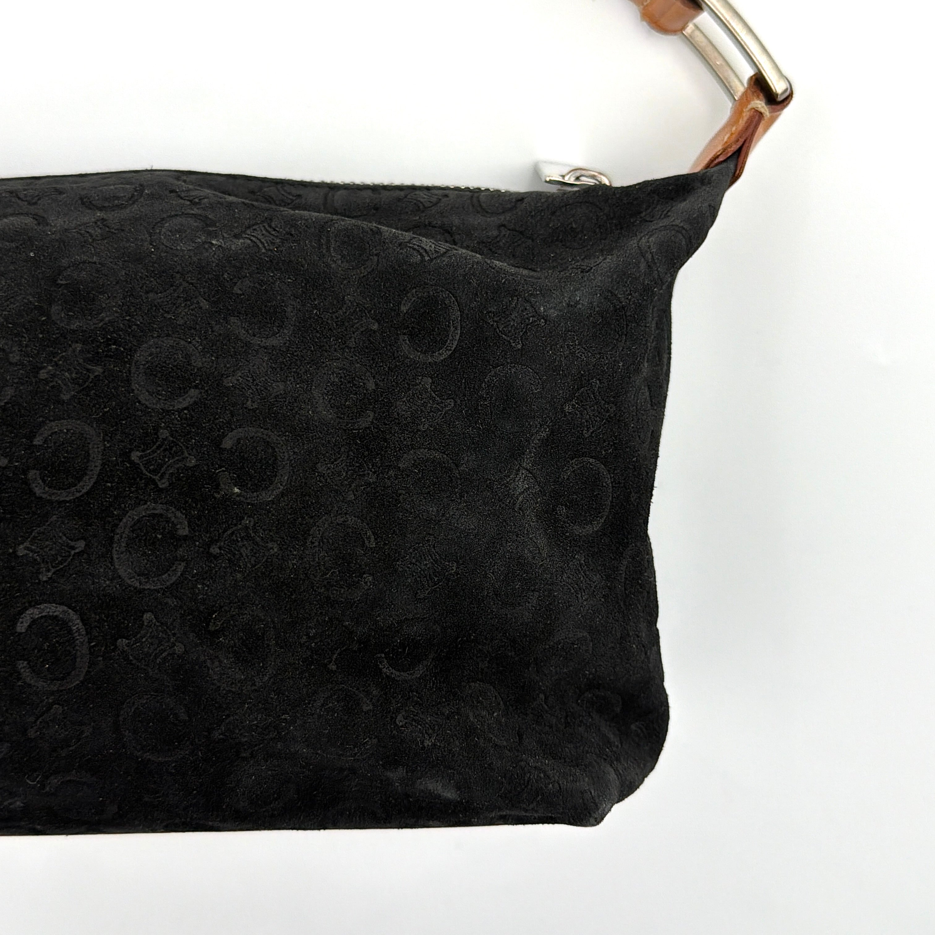 Celine black suede shoulder bag with embossed Triomphe motif, tan leather strap and silver-tone hardware, displayed from the front.