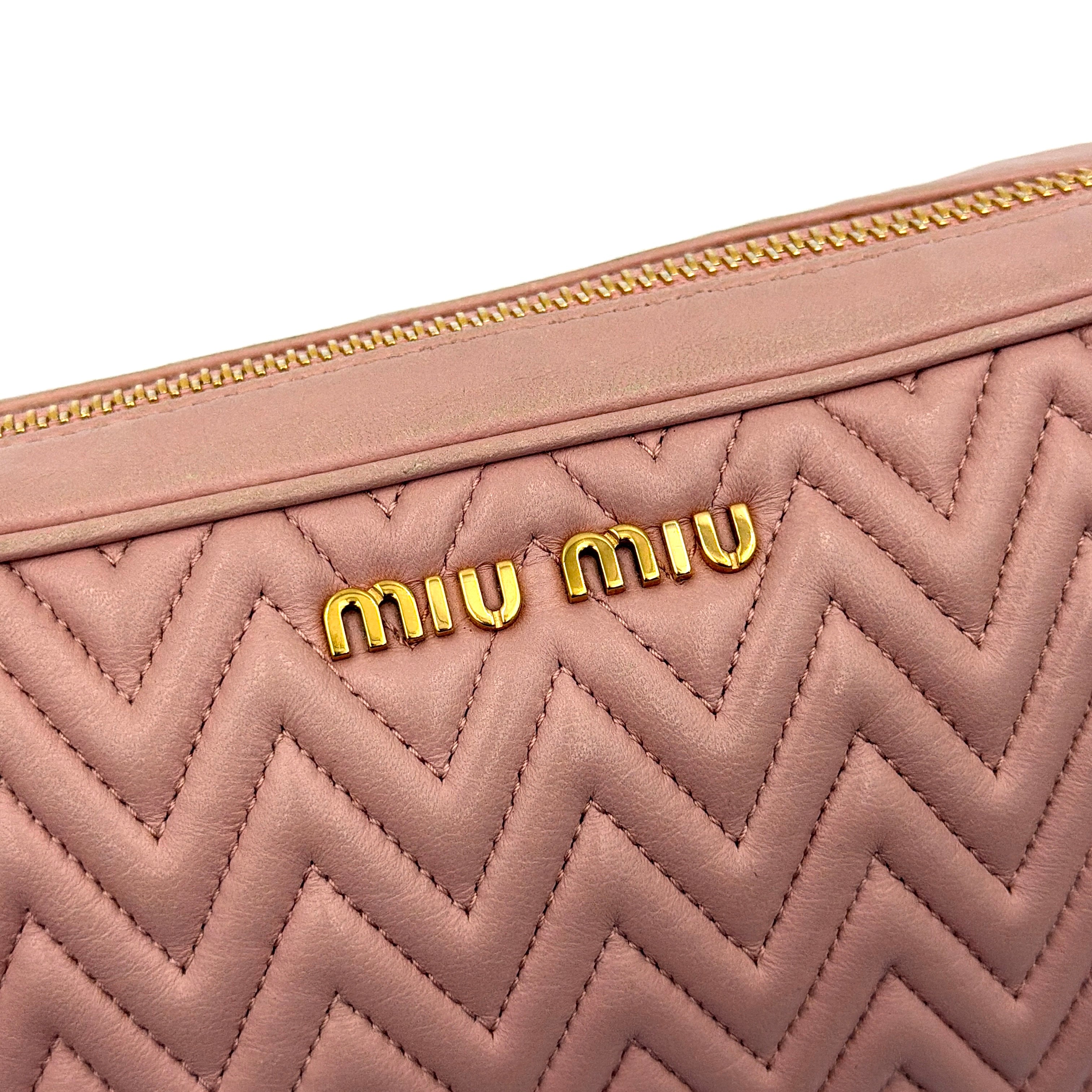 Miu Miu dusty pink quilted nappa mini crossbody bag with gold-tone chain strap and zip closure, showcased on a clean white background.