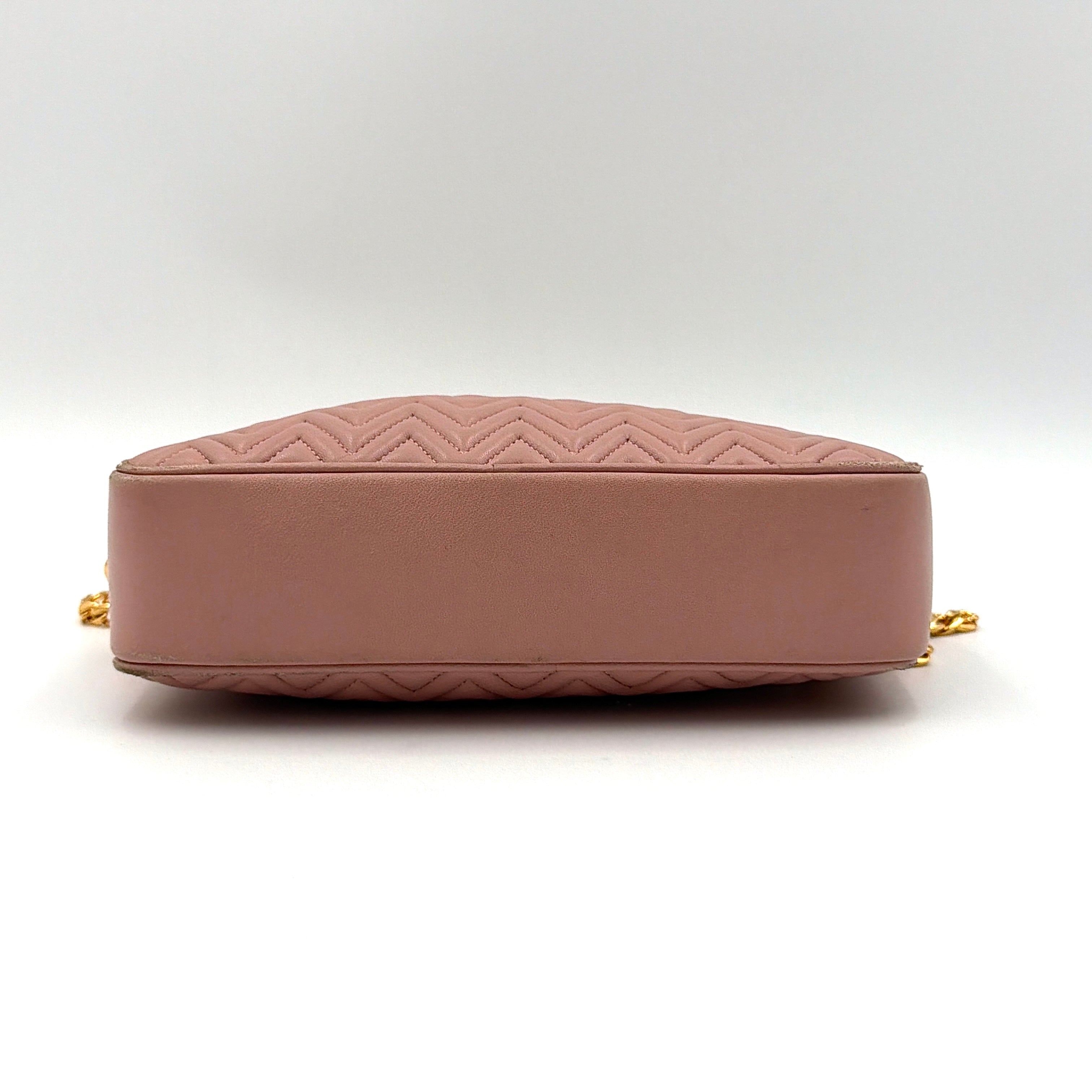 Miu Miu dusty pink quilted nappa mini crossbody bag with gold-tone chain strap and zip closure, showcased on a clean white background.