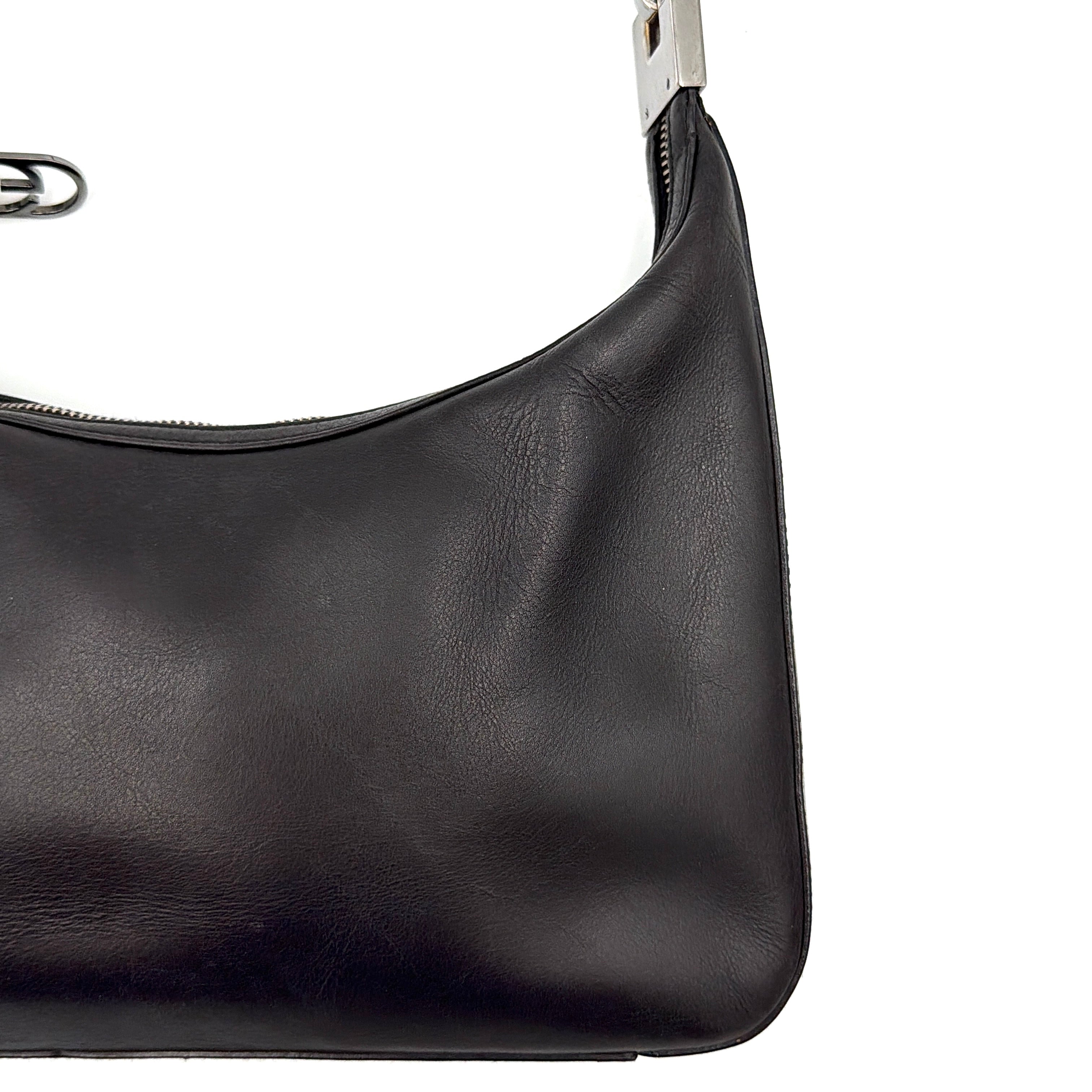 Gucci GG Leather Hobo Shoulder Bag in black smooth leather with sculptural silver-tone hardware and signature GG zip pull.