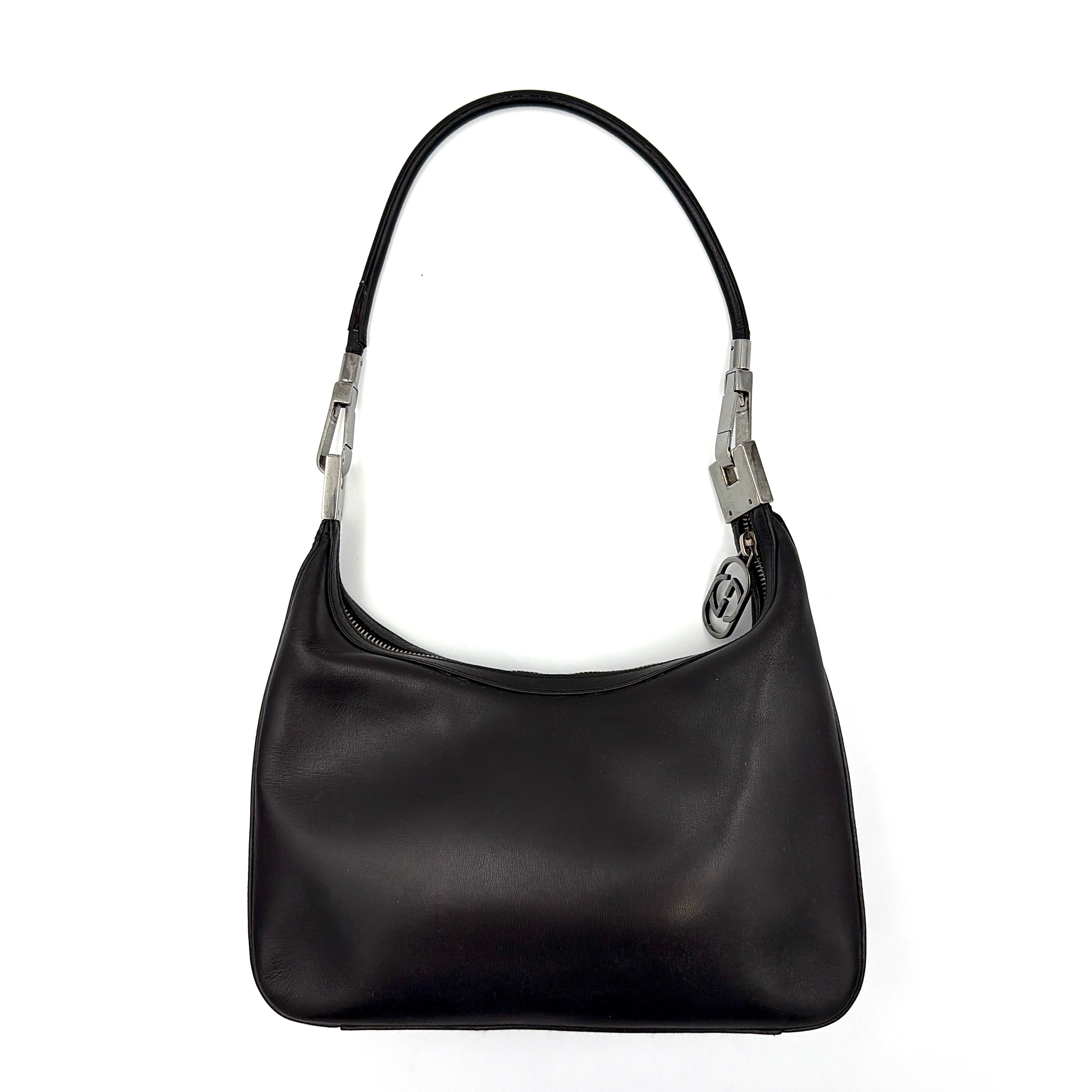 Gucci GG Leather Hobo Shoulder Bag in black smooth leather with sculptural silver-tone hardware and signature GG zip pull.
