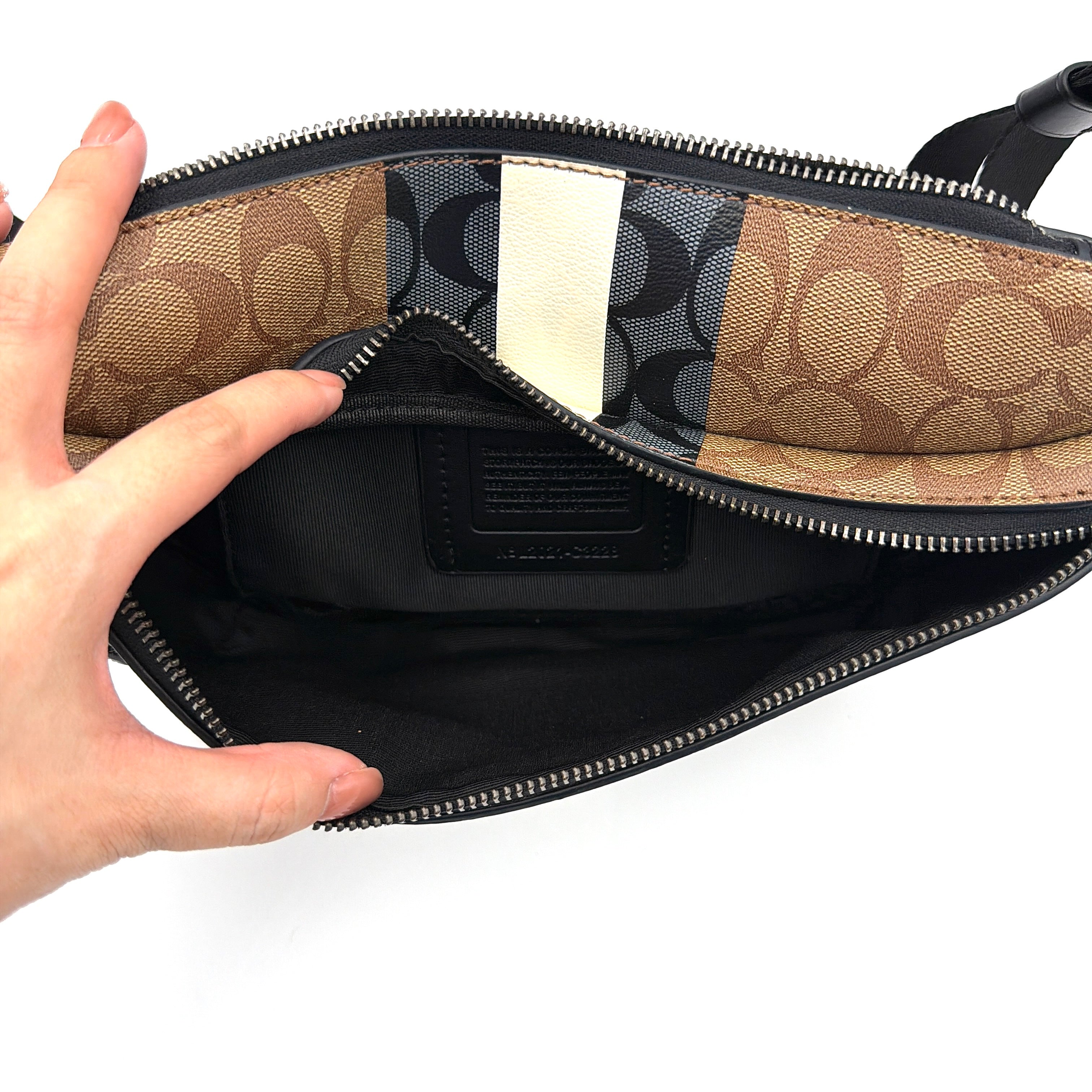Coach Signature Warren Stripe Belt Bag in beige canvas with black and ivory vertical stripes and adjustable black strap.