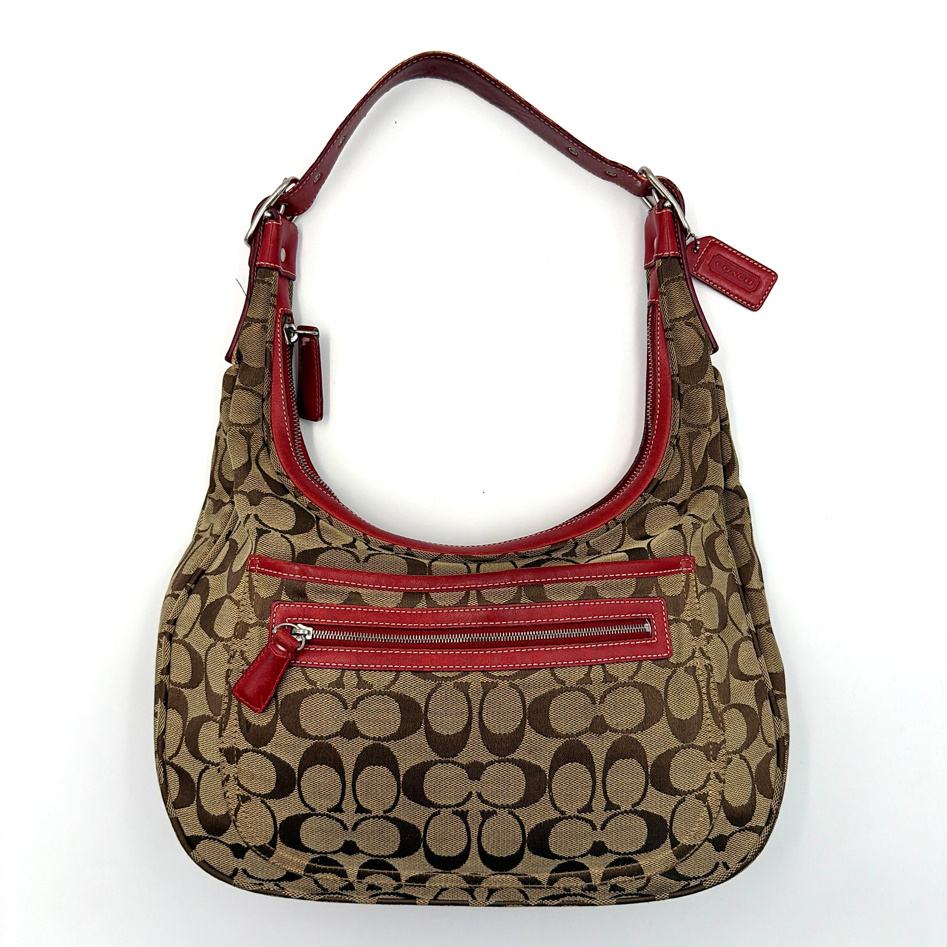 Coach Signature Hamilton Hobo Shoulder Bag in beige monogram canvas with striking red leather trim and a wide hobo silhouette.