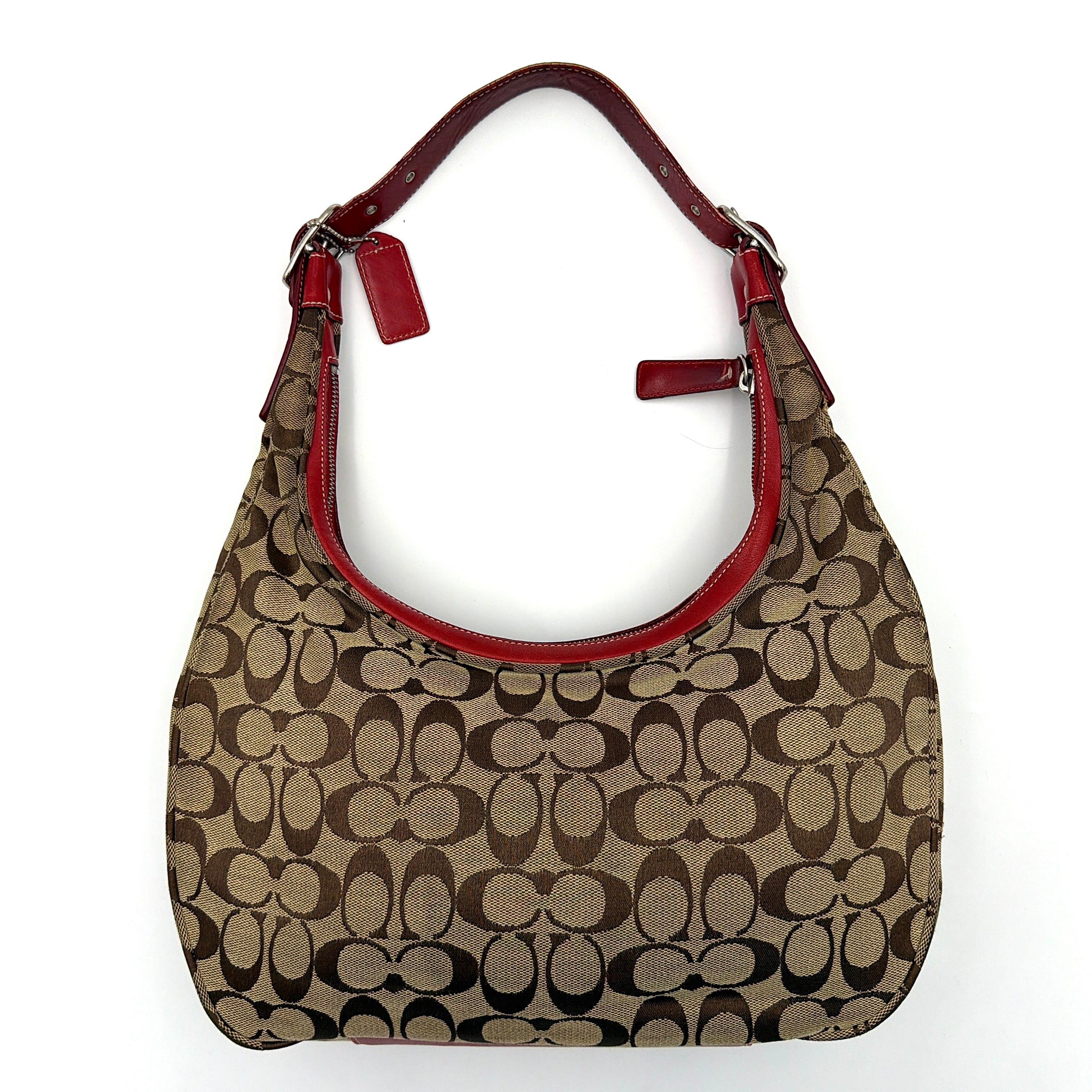 Coach Signature Hamilton Hobo Shoulder Bag in beige monogram canvas with striking red leather trim and a wide hobo silhouette.
